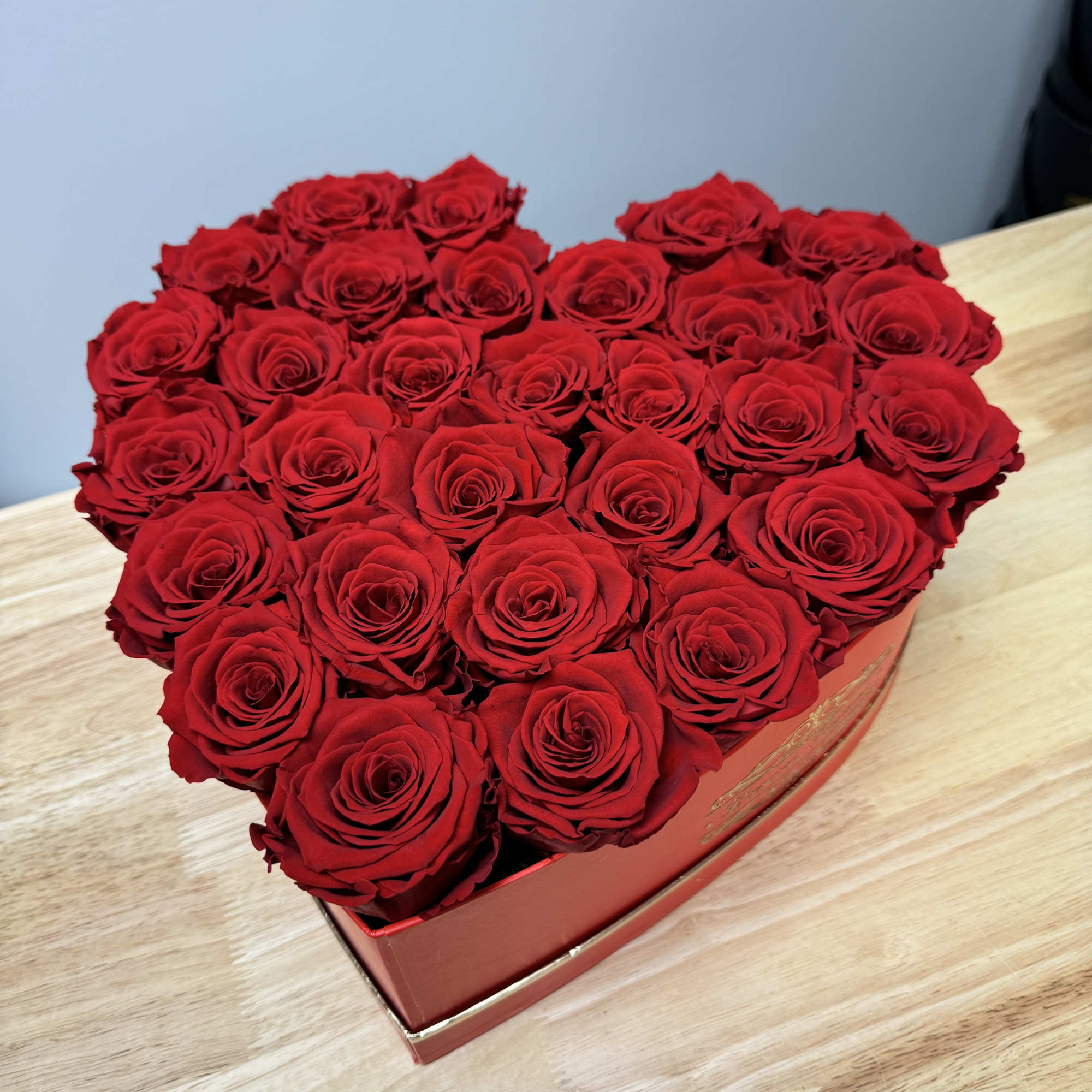 Heart-shaped box filled with red roses, photo 2 of 3