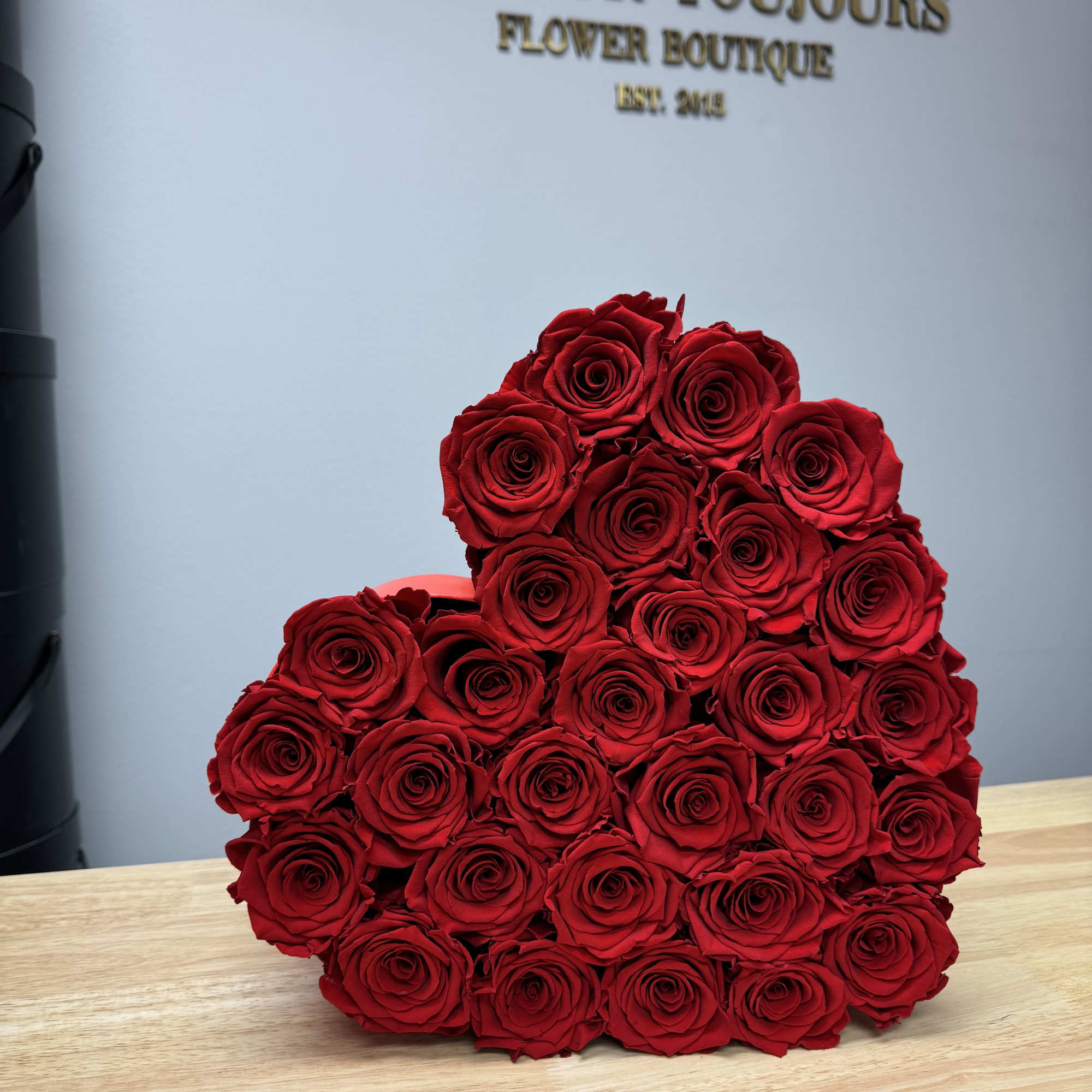 Large bouquet of red roses arranged in a rounded cluster