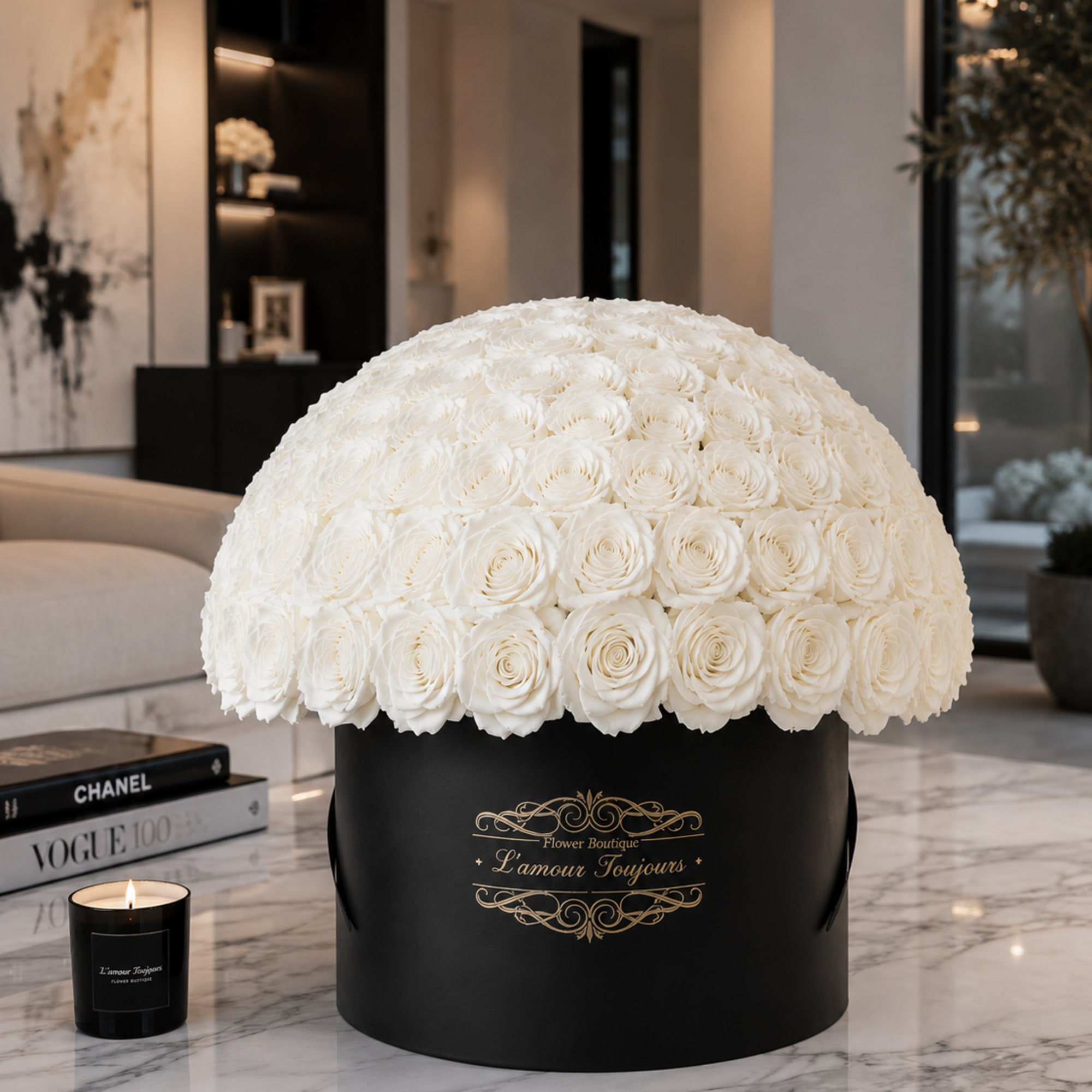 Large dome of white roses in a black hatbox with a candle beside it.