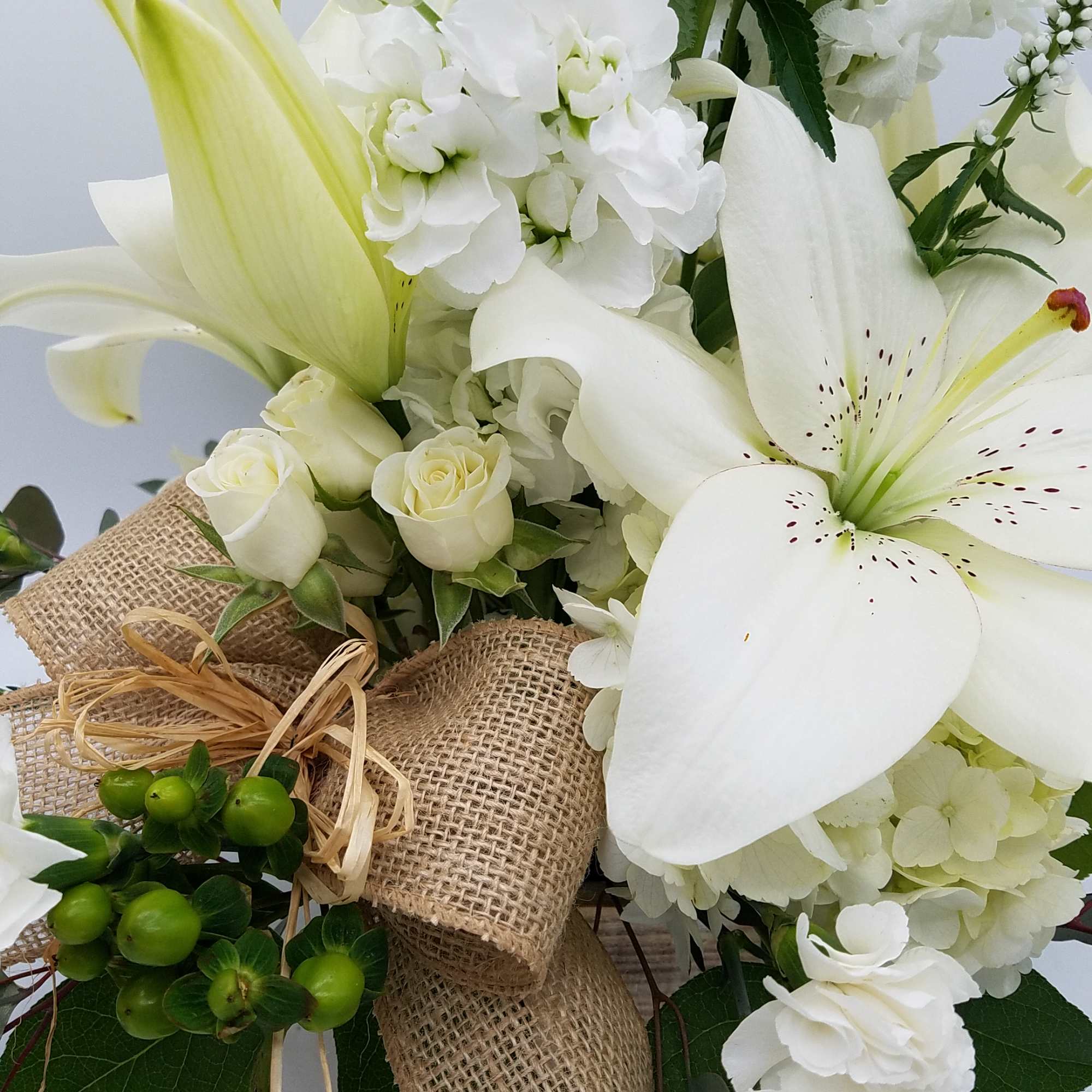 White lily and rose bouquet with burlap ribbon
