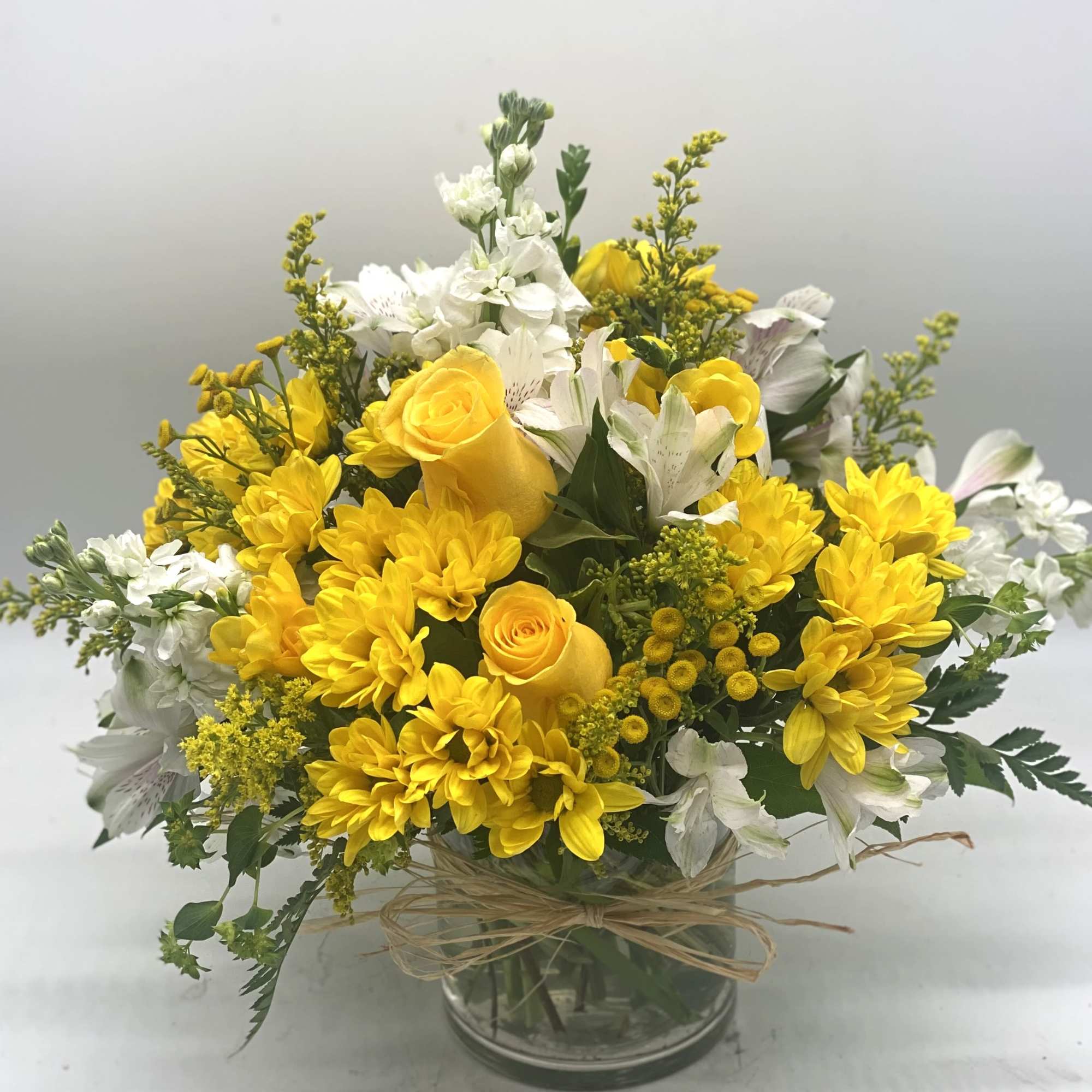 A beautiful and bright mix of yellows and whites designed in a, photo 2 of 5