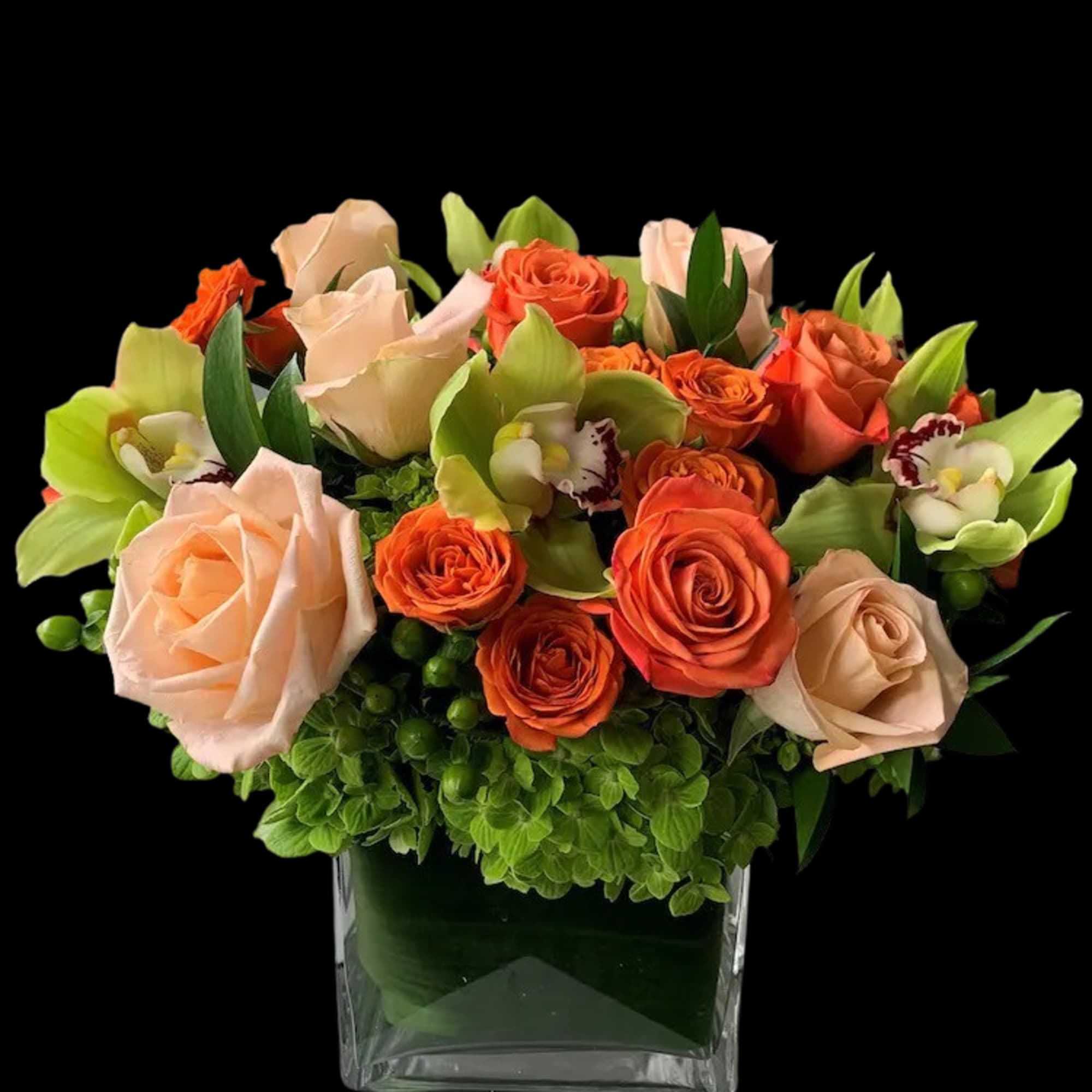 Orange and blush roses with green orchids in a glass vase