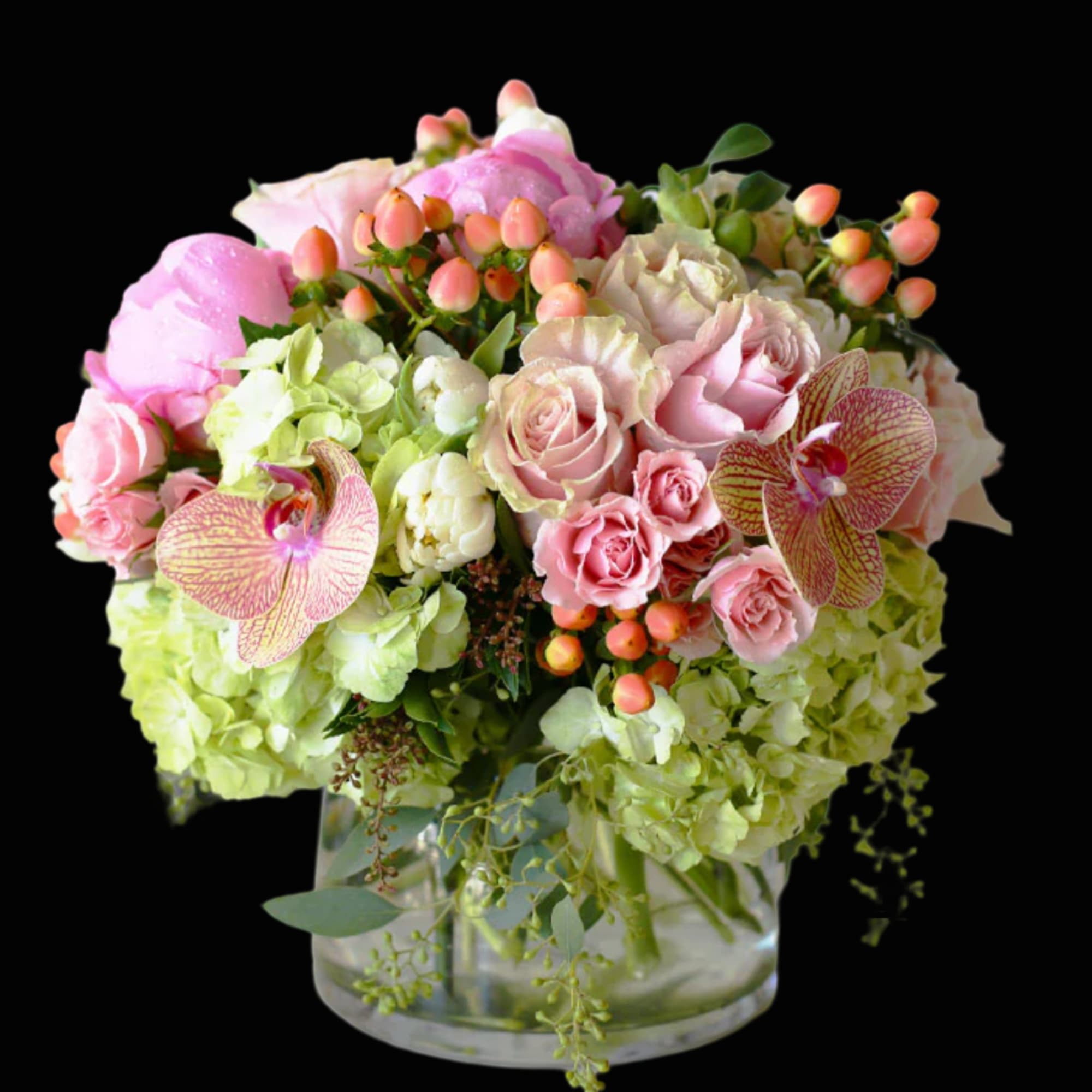 Pink and green floral arrangement in a clear glass vase