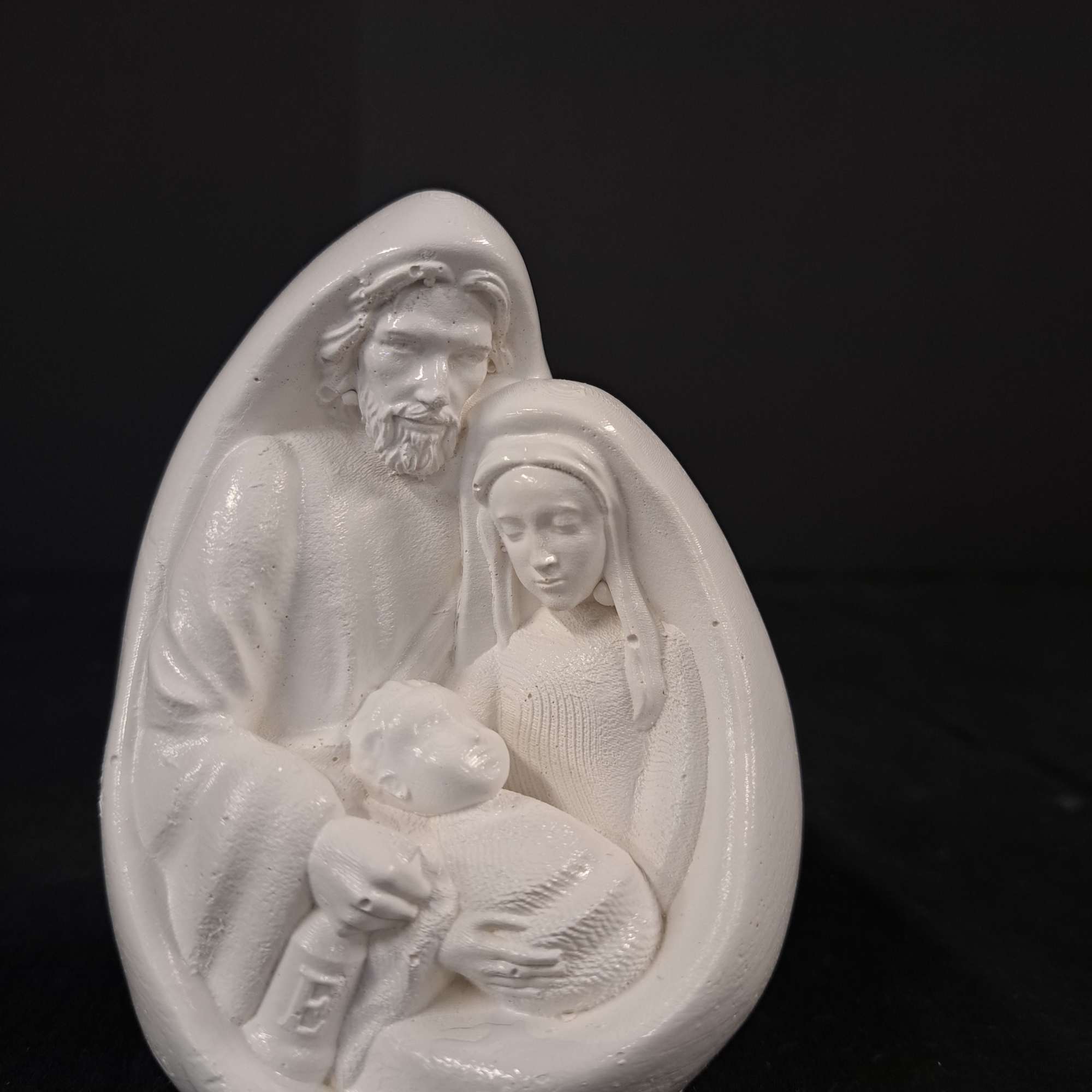 White nativity figurine of Mary, Joseph, and baby Jesus