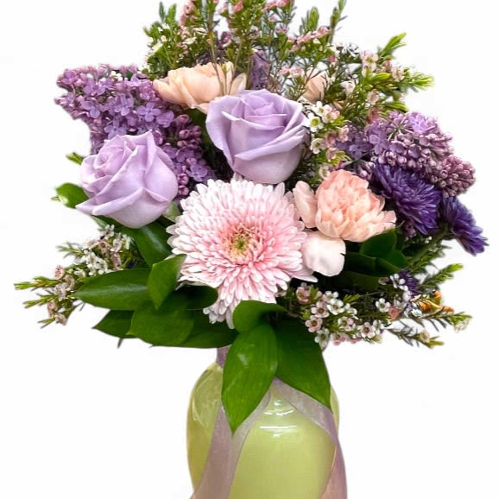 Lavender roses and pink flowers in a glass vase with ribbon