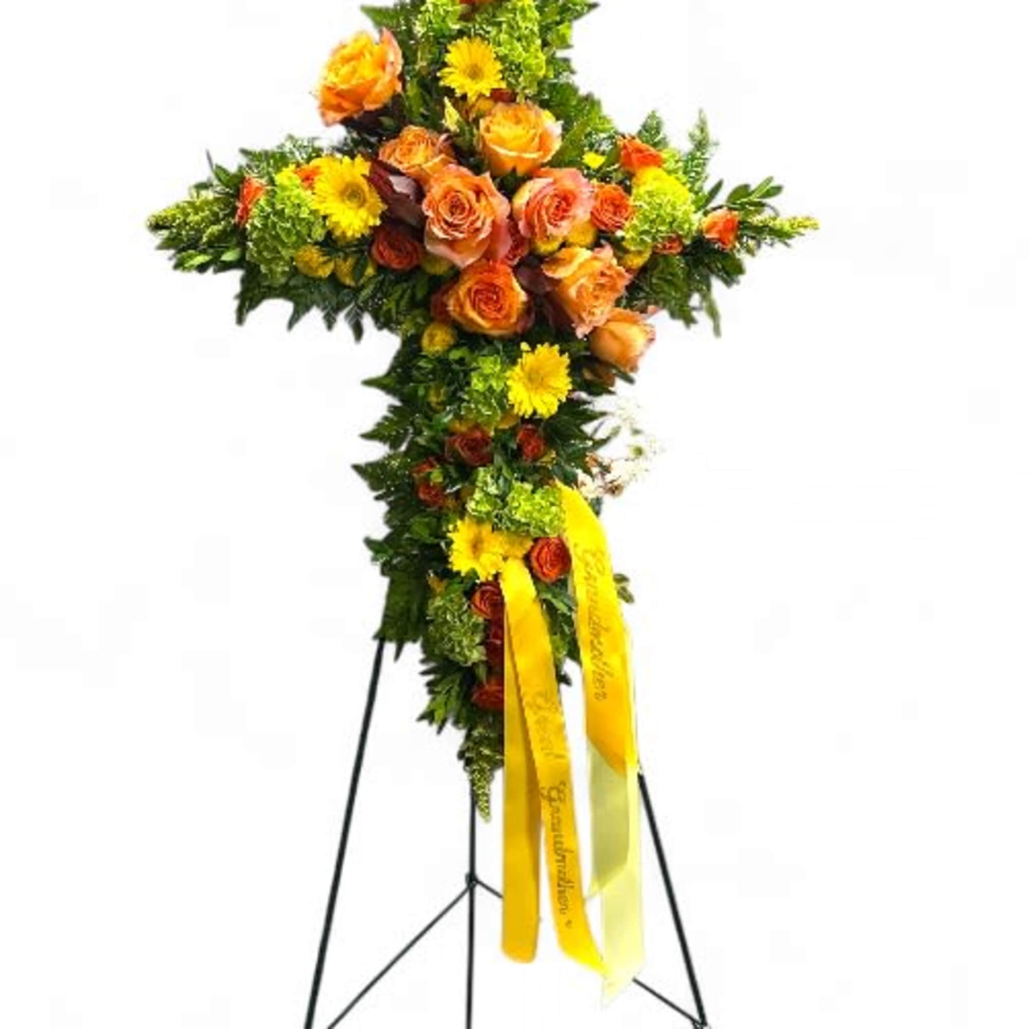 Standing floral cross with orange roses and yellow daisies on an easel