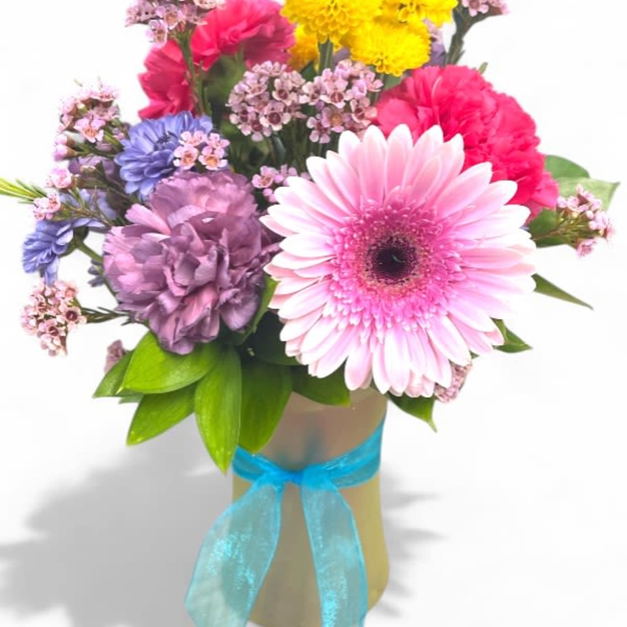Mixed bouquet with pink gerbera daisies and purple flowers in a ribbon-tied vase