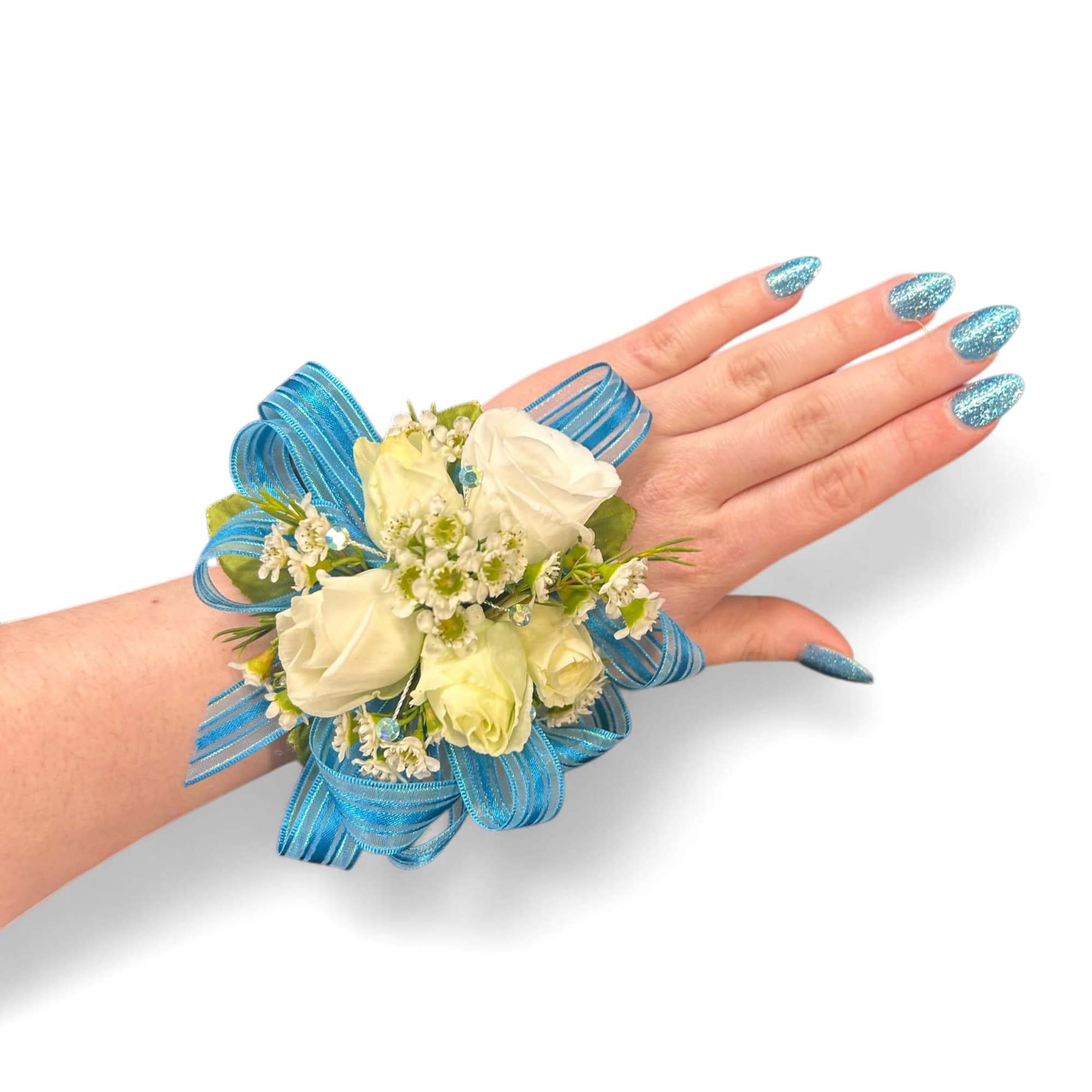White rose wrist corsage with blue ribbon on a hand