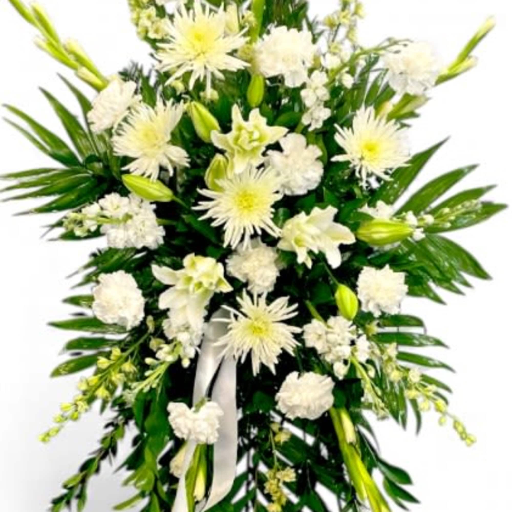 White funeral spray with lilies, chrysanthemums, and greenery