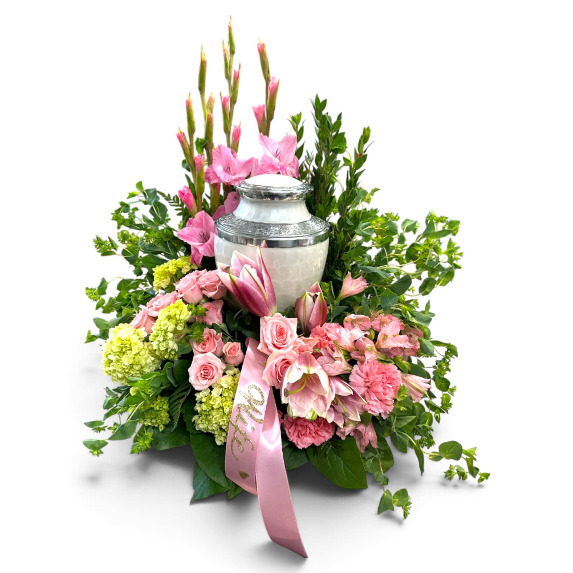 Pink floral arrangement around a silver urn with a pink ribbon