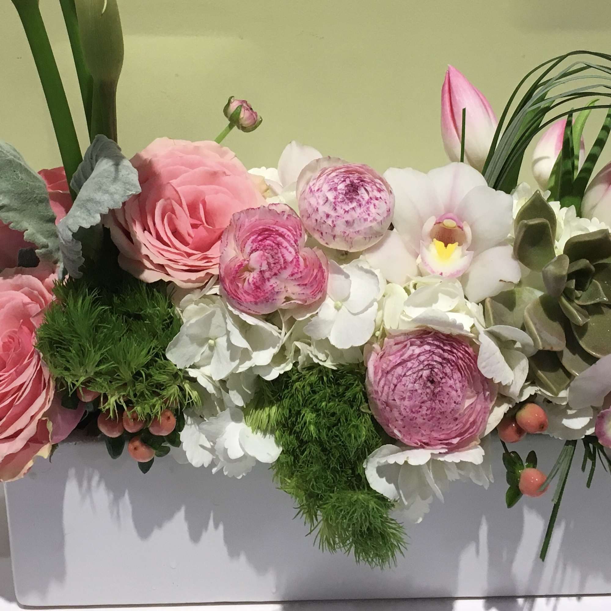 Pink and white floral arrangement in a white rectangular box