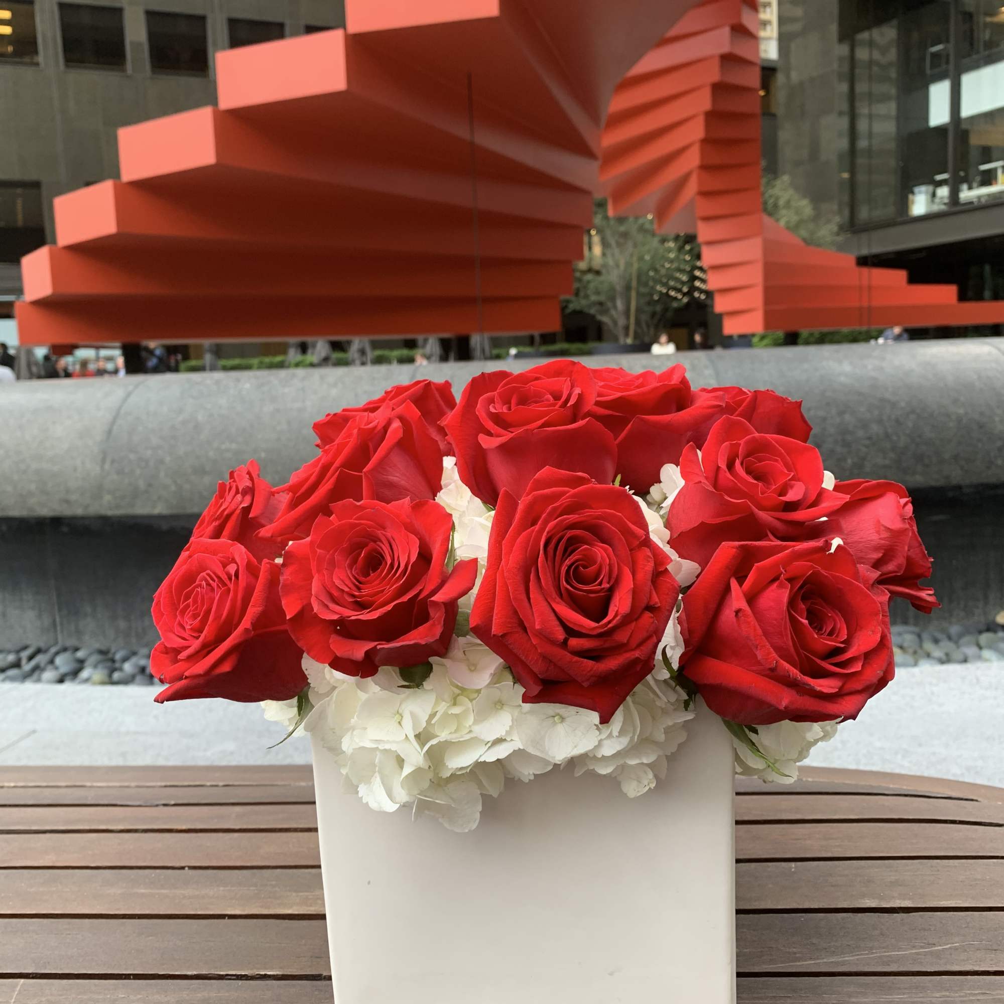 Red roses arranged in a white square vase with white hydrangeas, photo 3 of 3