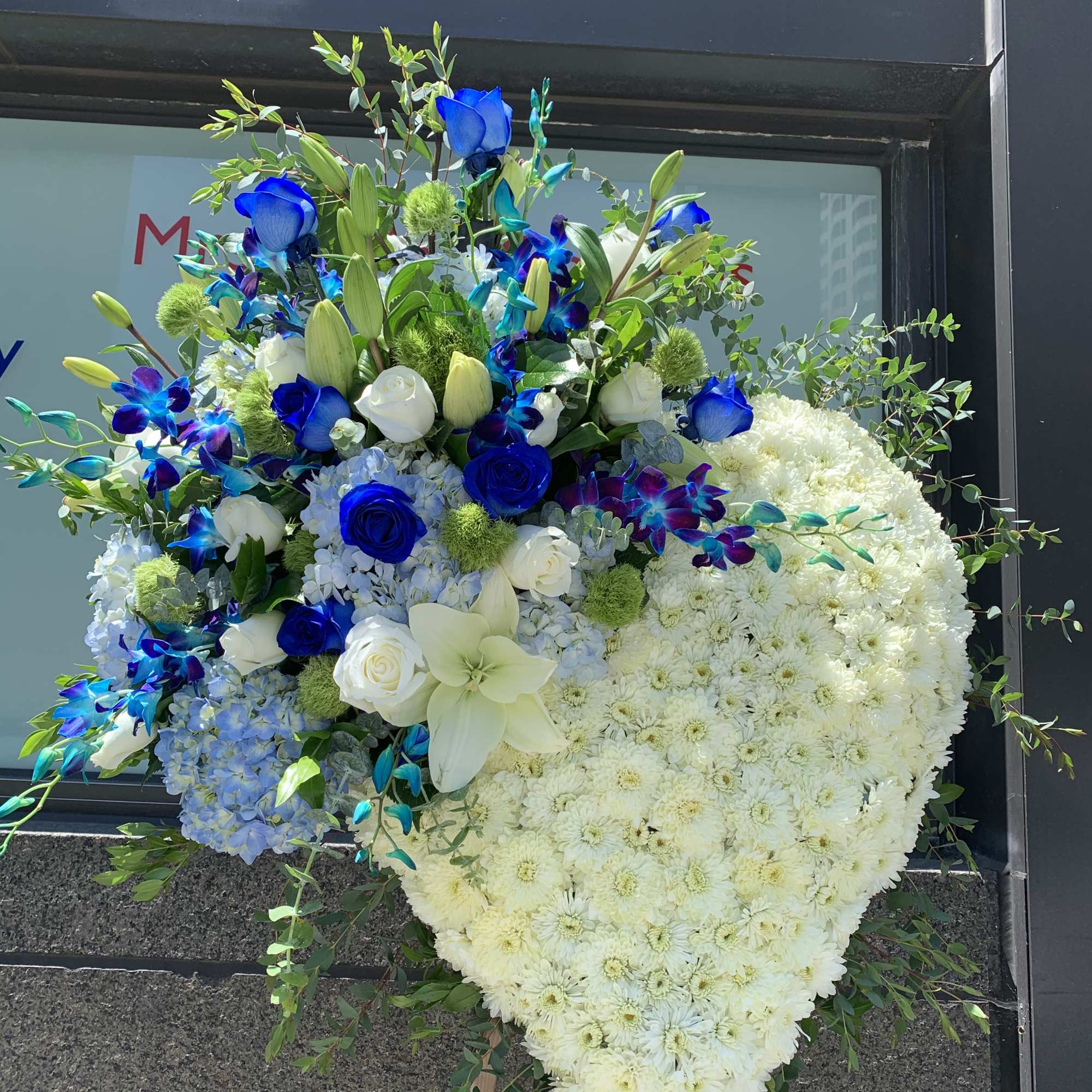 Large heart-shaped floral spray with white and blue flowers