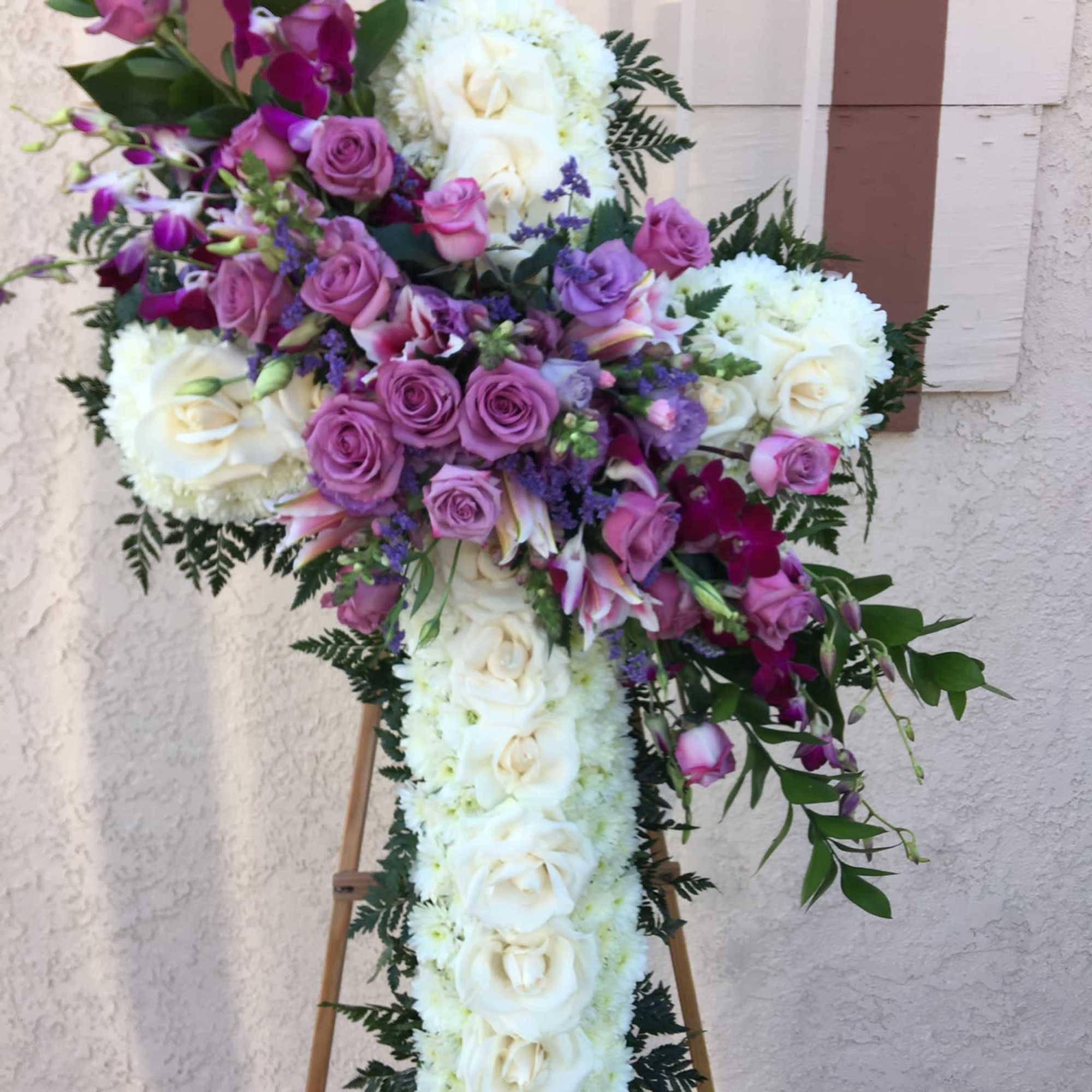 Standing floral cross with white and purple flowers