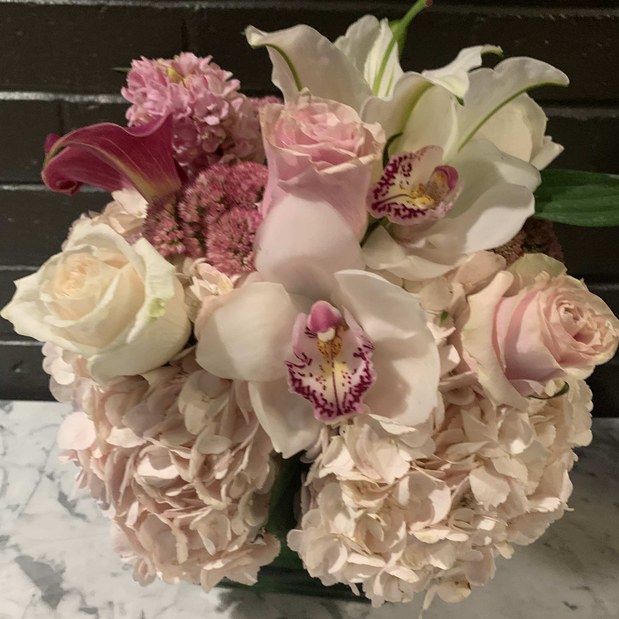Bouquet of pink and white flowers with orchids and roses
