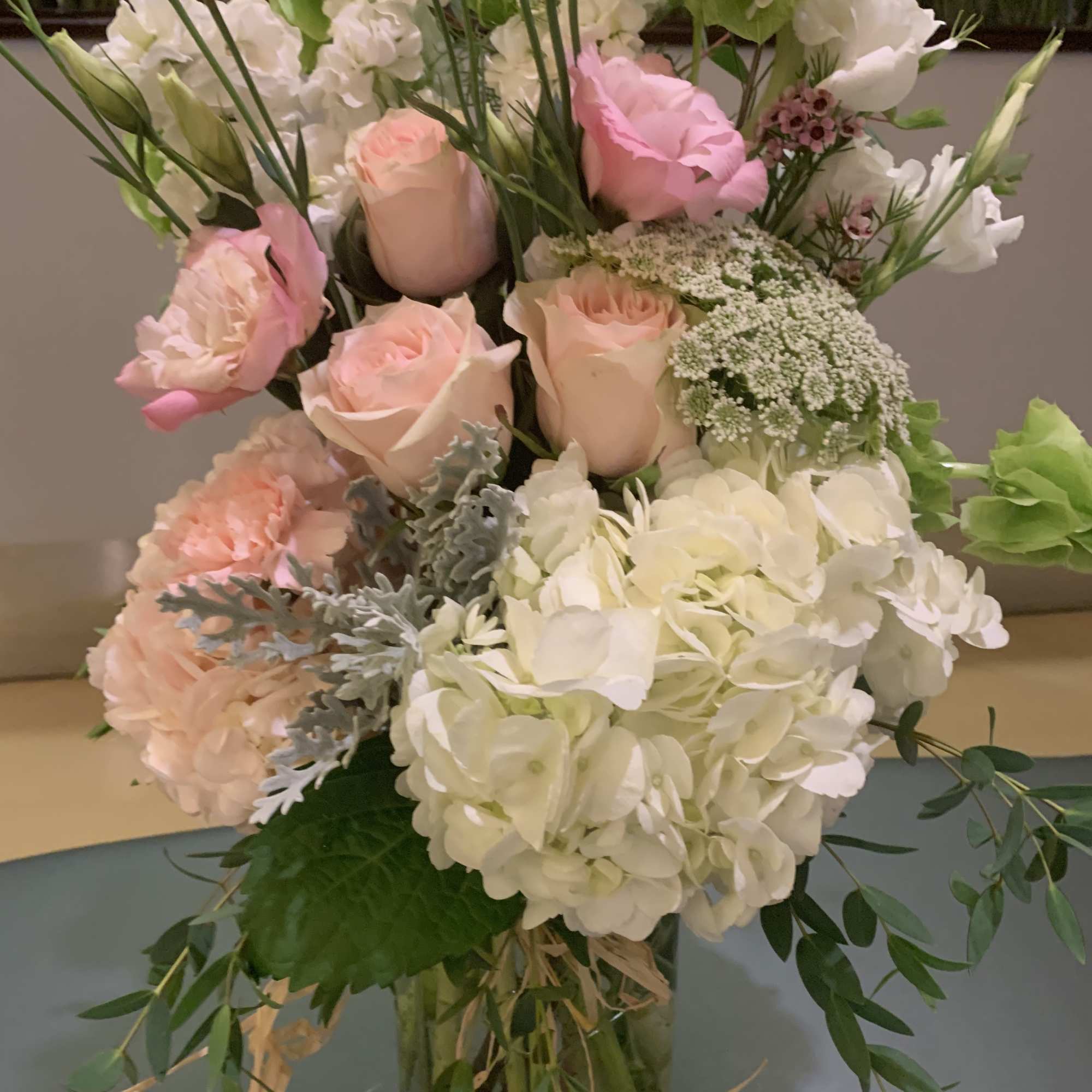 Pink and white floral arrangement in a glass vase