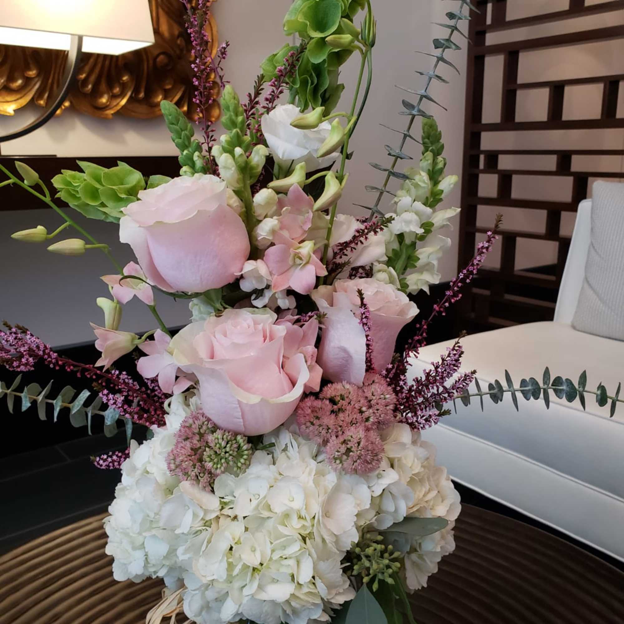 Tall bouquet of pale pink roses, white hydrangeas, and green blooms