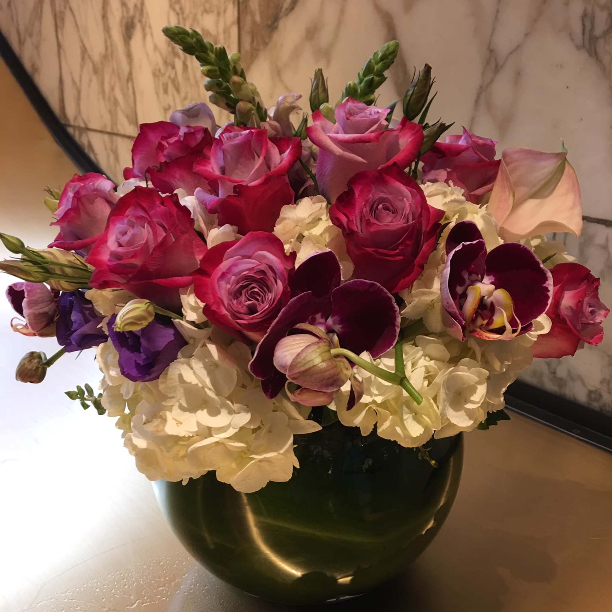 Pink and purple mixed bouquet in a dark vase