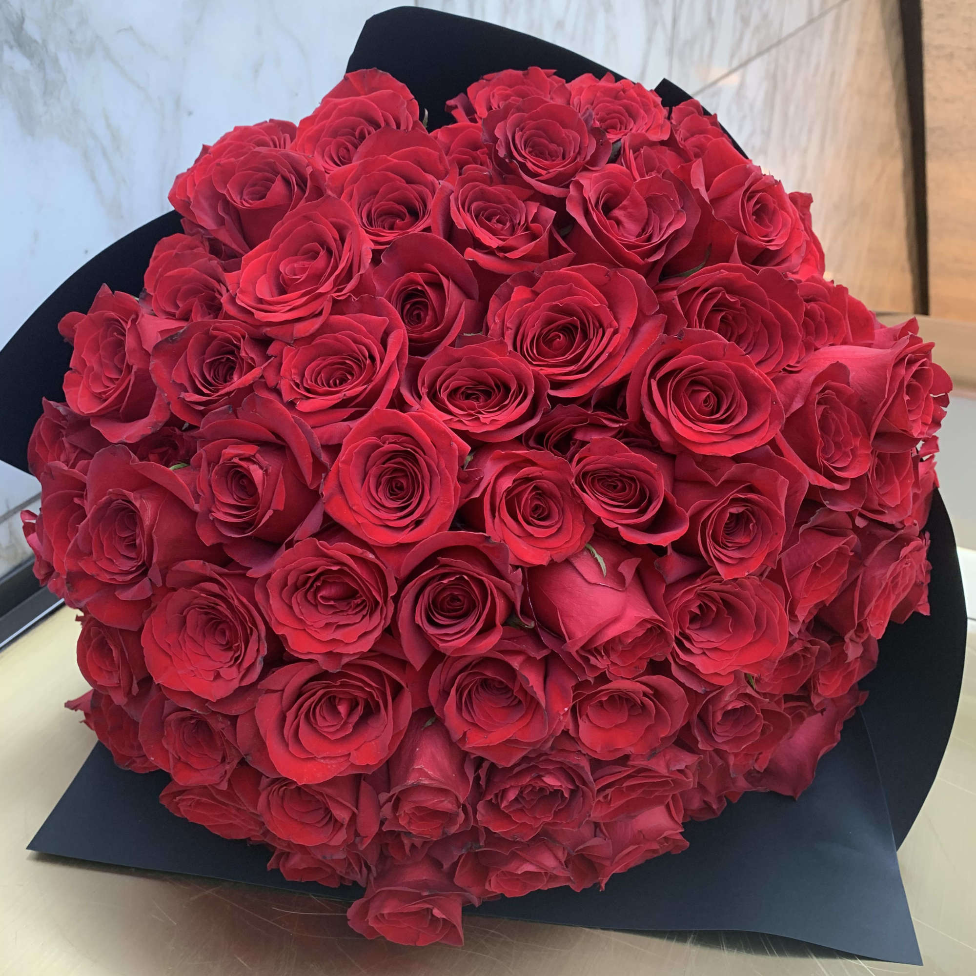 Large bouquet of red roses wrapped in black paper, photo 5 of 5