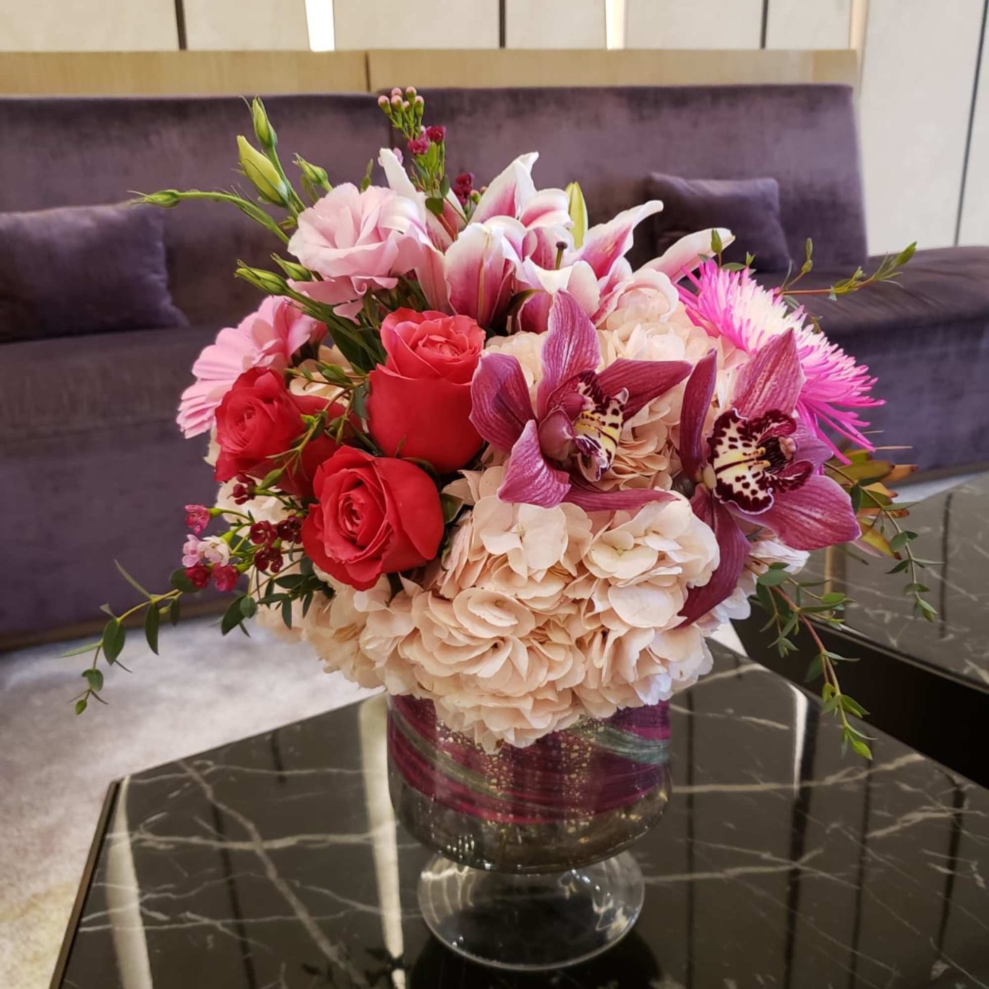 Pink and red floral arrangement in a glass vase