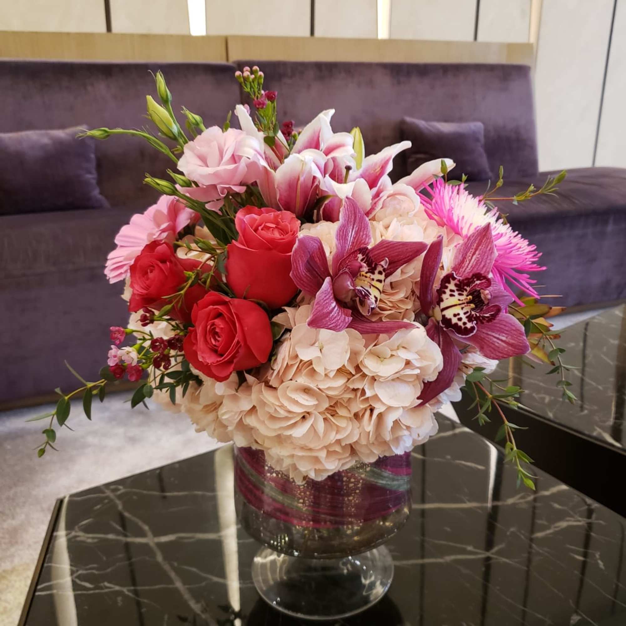 Mixed pink and cream flower arrangement in a glass vase