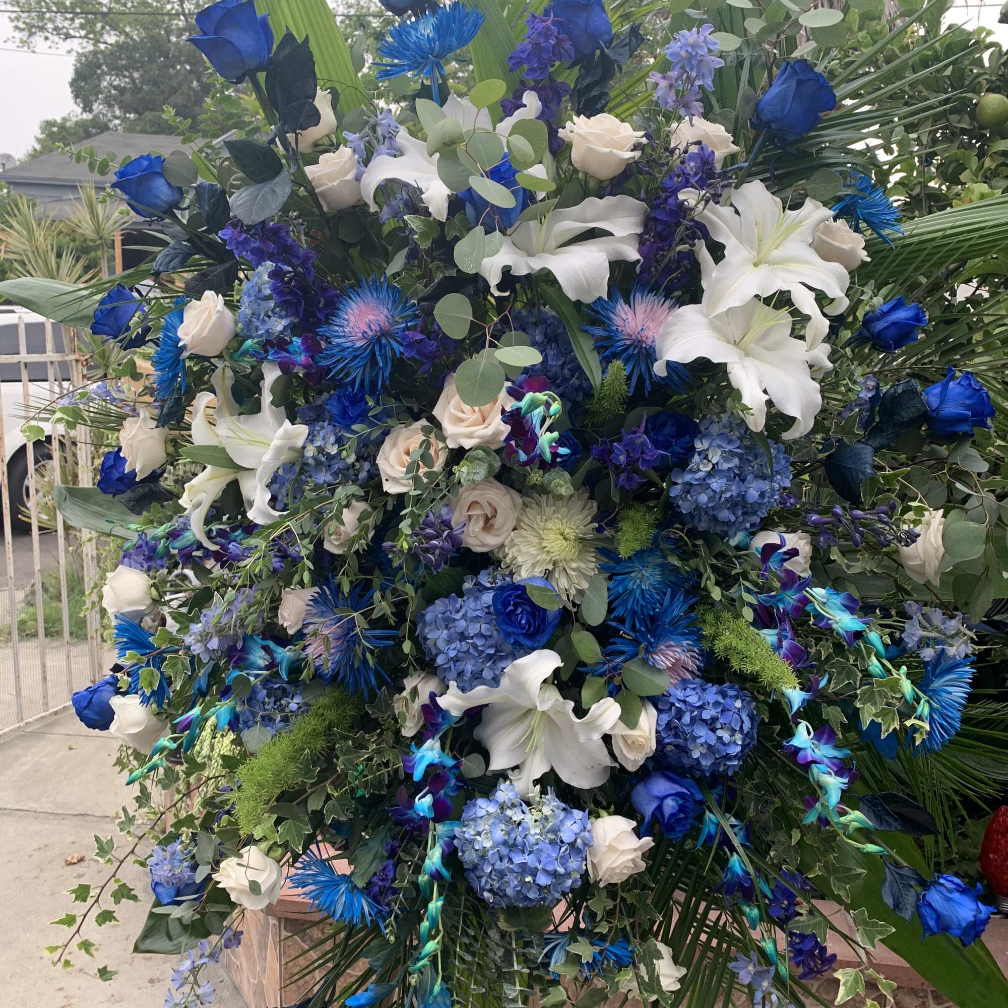Large blue and white floral spray with lilies and roses