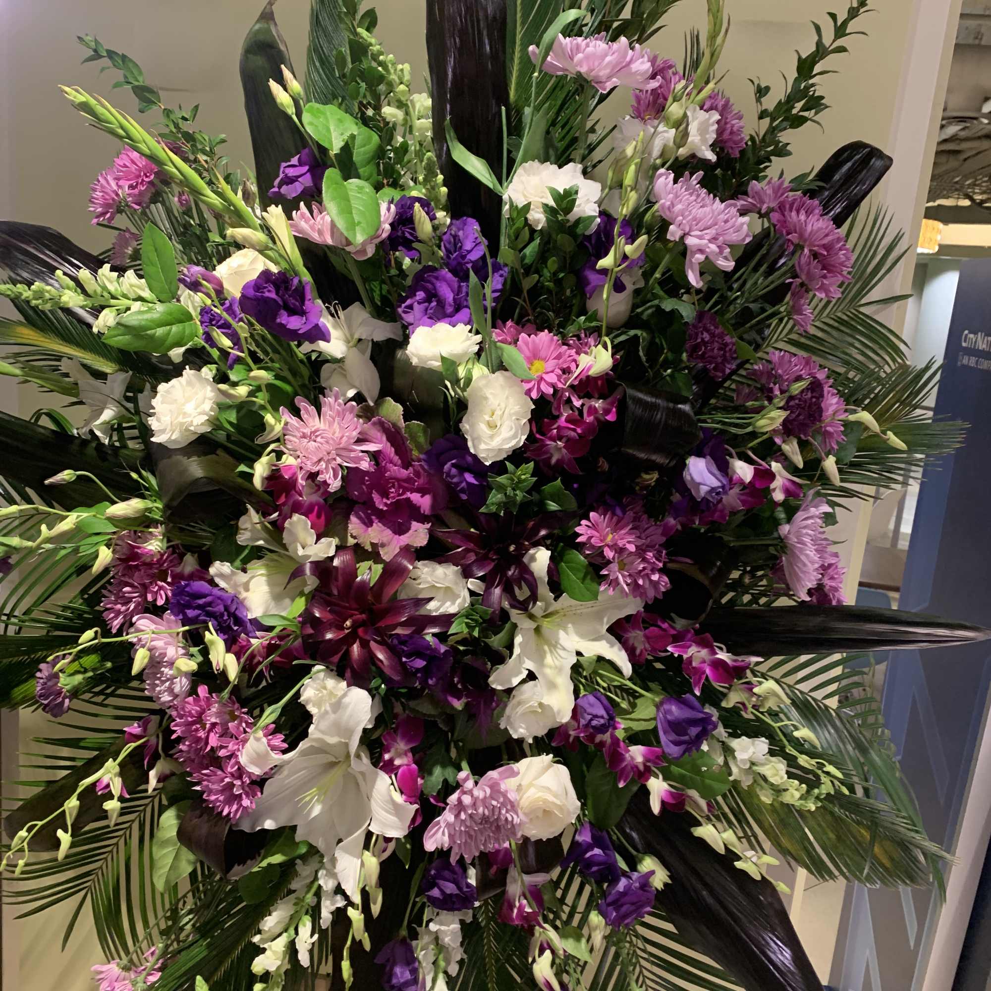 Large standing spray of purple, pink, and white flowers