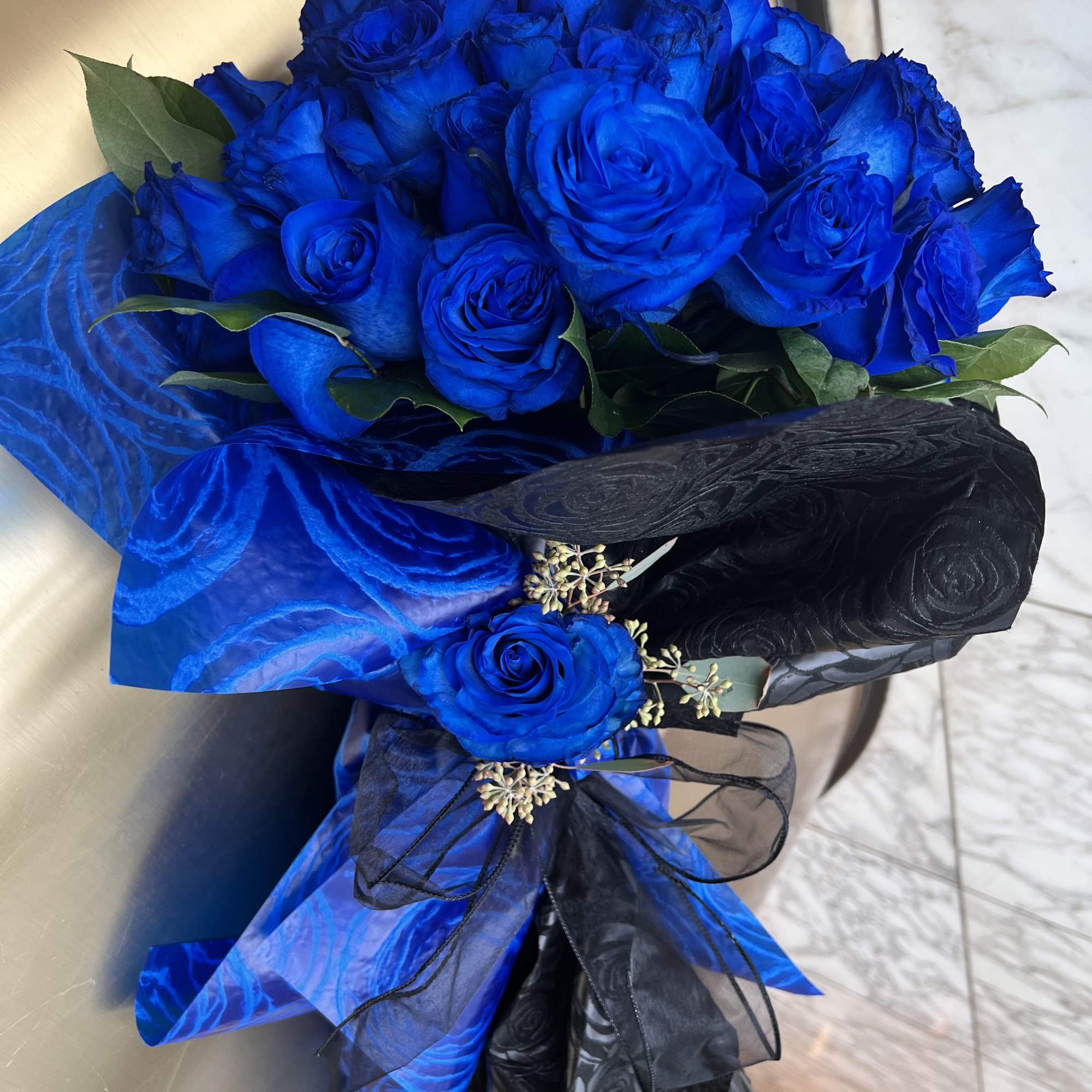 Bouquet of vivid blue roses wrapped in blue and black paper, photo 5 of 5