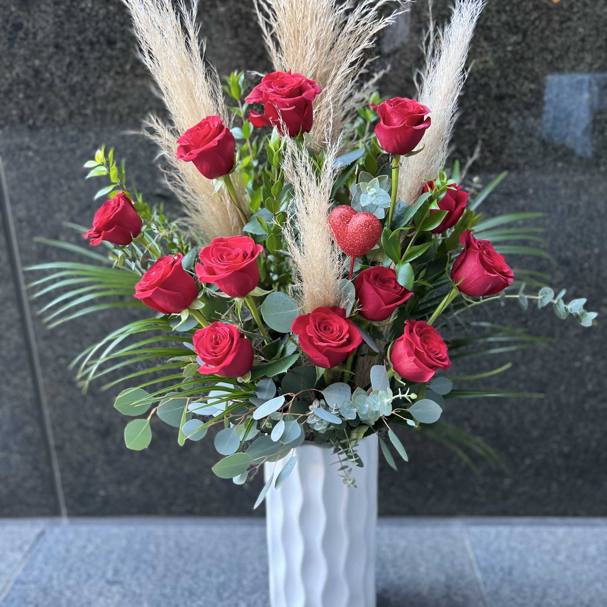 Tall bouquet of red roses with pampas grass in a white vase, photo 5 of 5