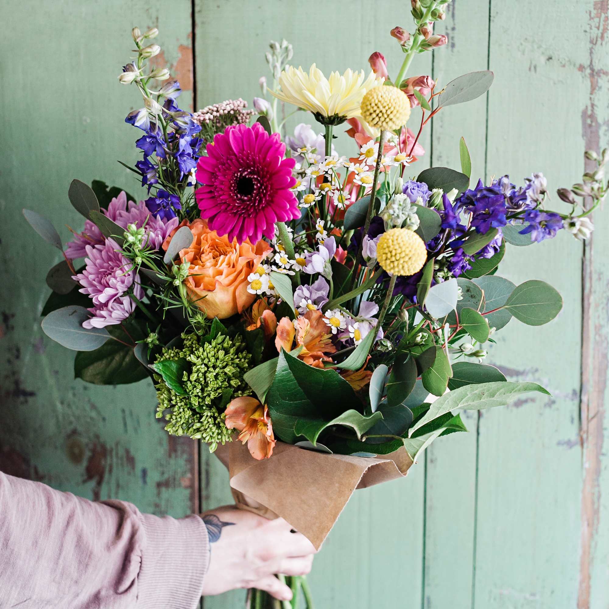 Mixed bouquet with a bright pink gerbera and orange rose