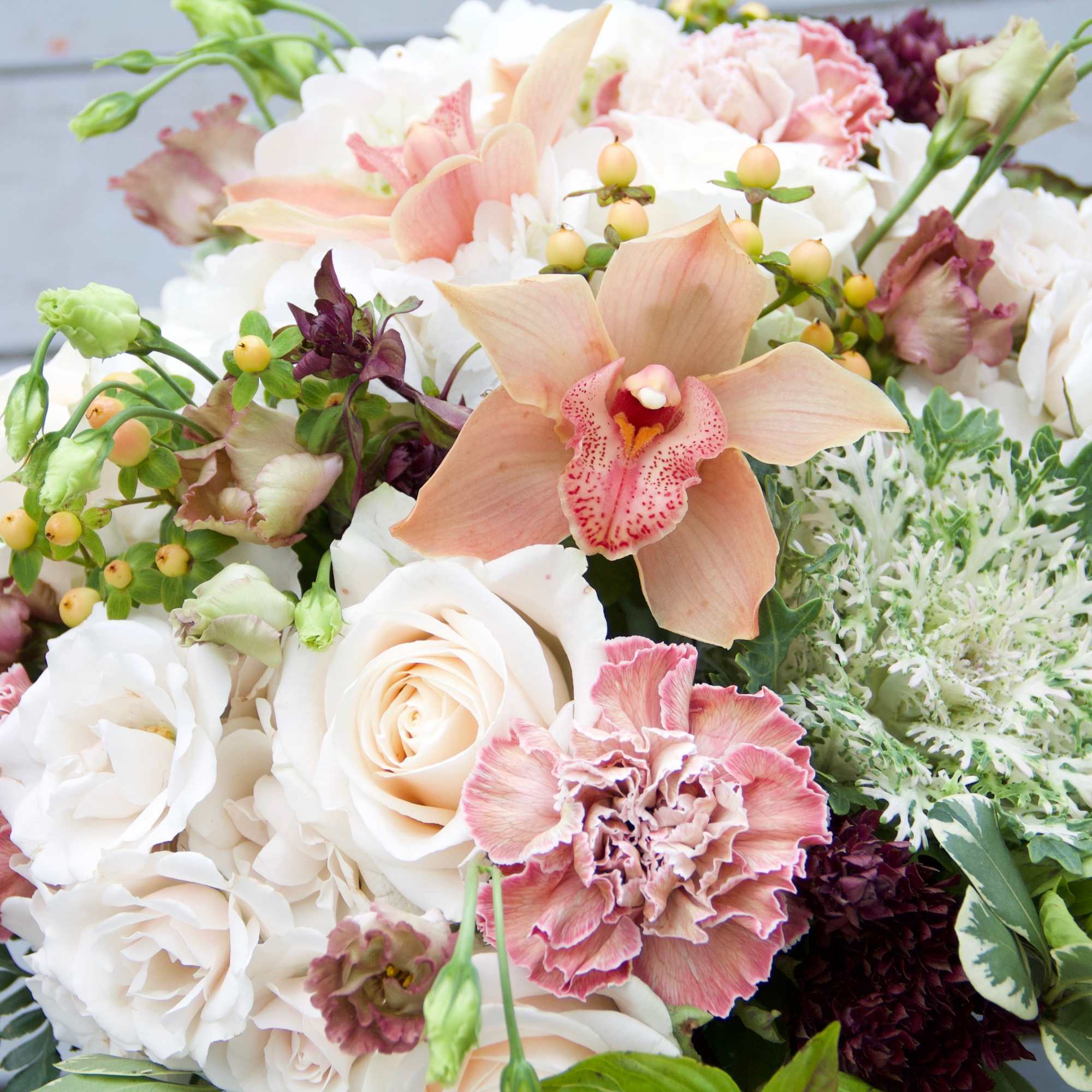 Bouquet of white and blush flowers with a peach orchid and roses