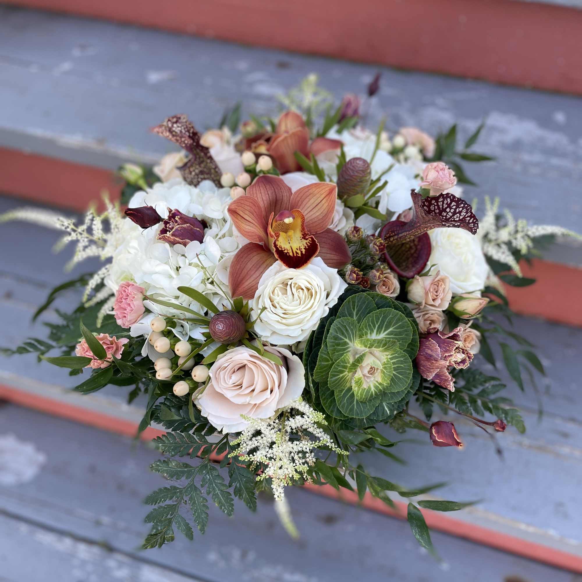 Mixed bouquet with orchids, roses, and white blooms