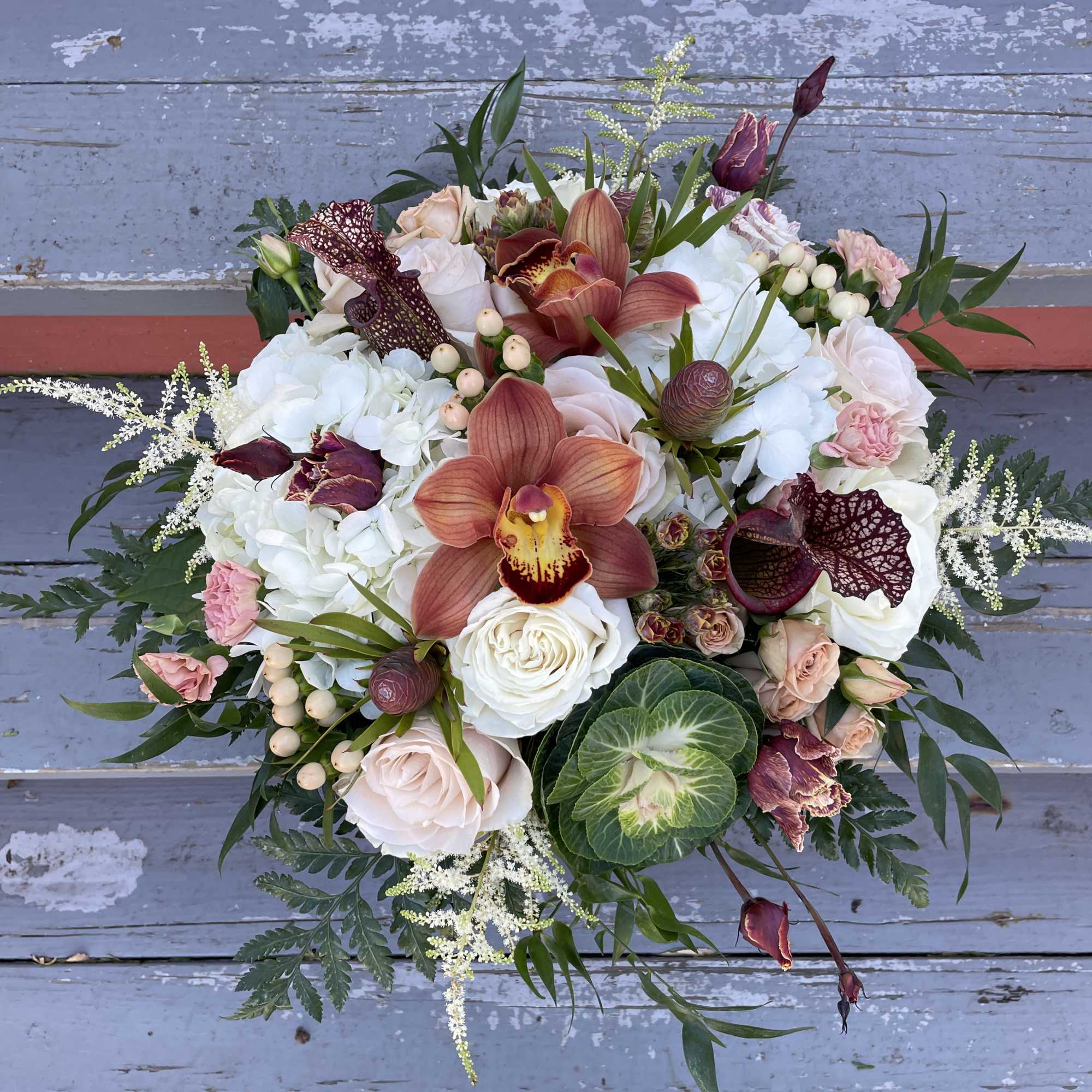 Mixed bouquet with orchids, roses, hydrangeas, and greenery