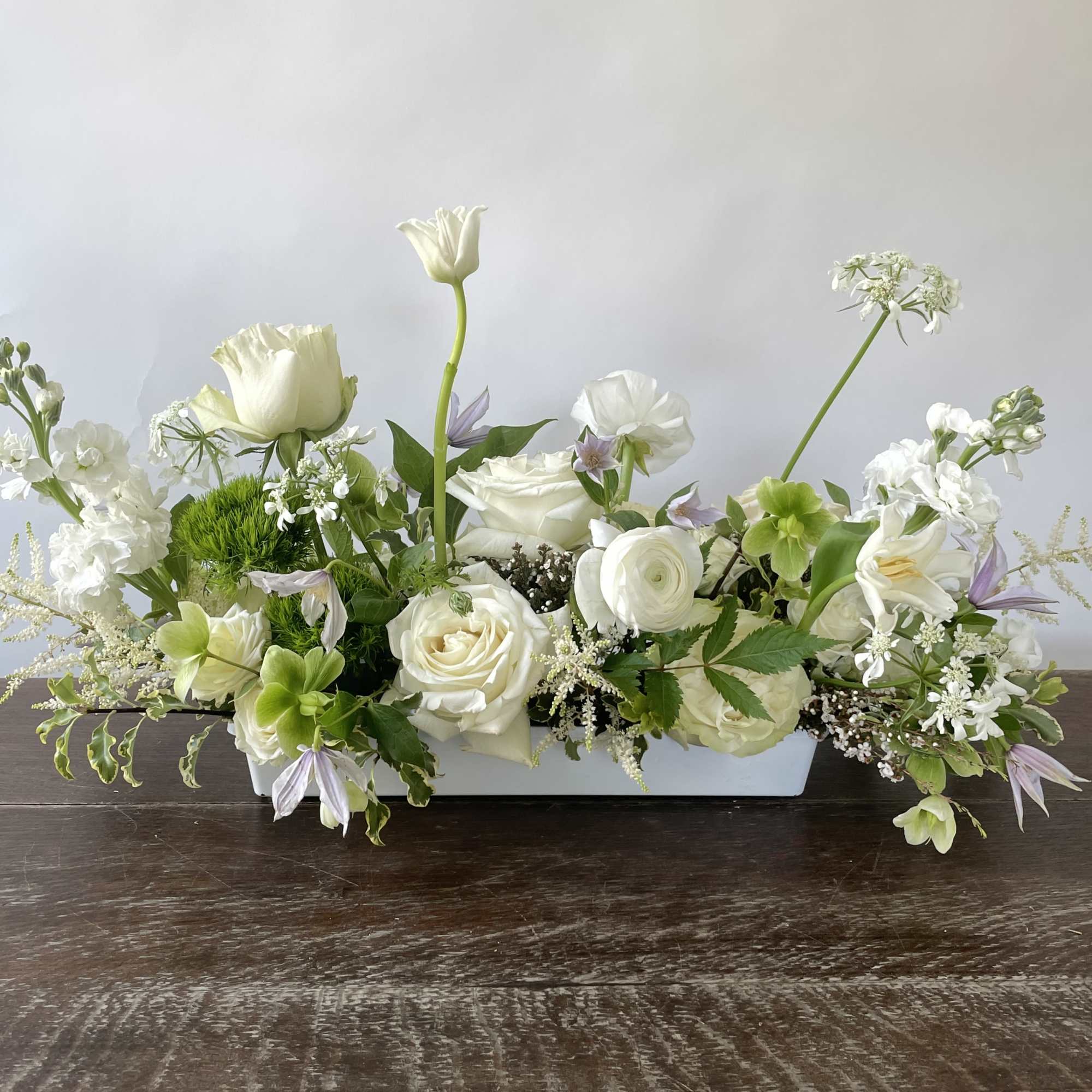White floral centerpiece in a low rectangular container