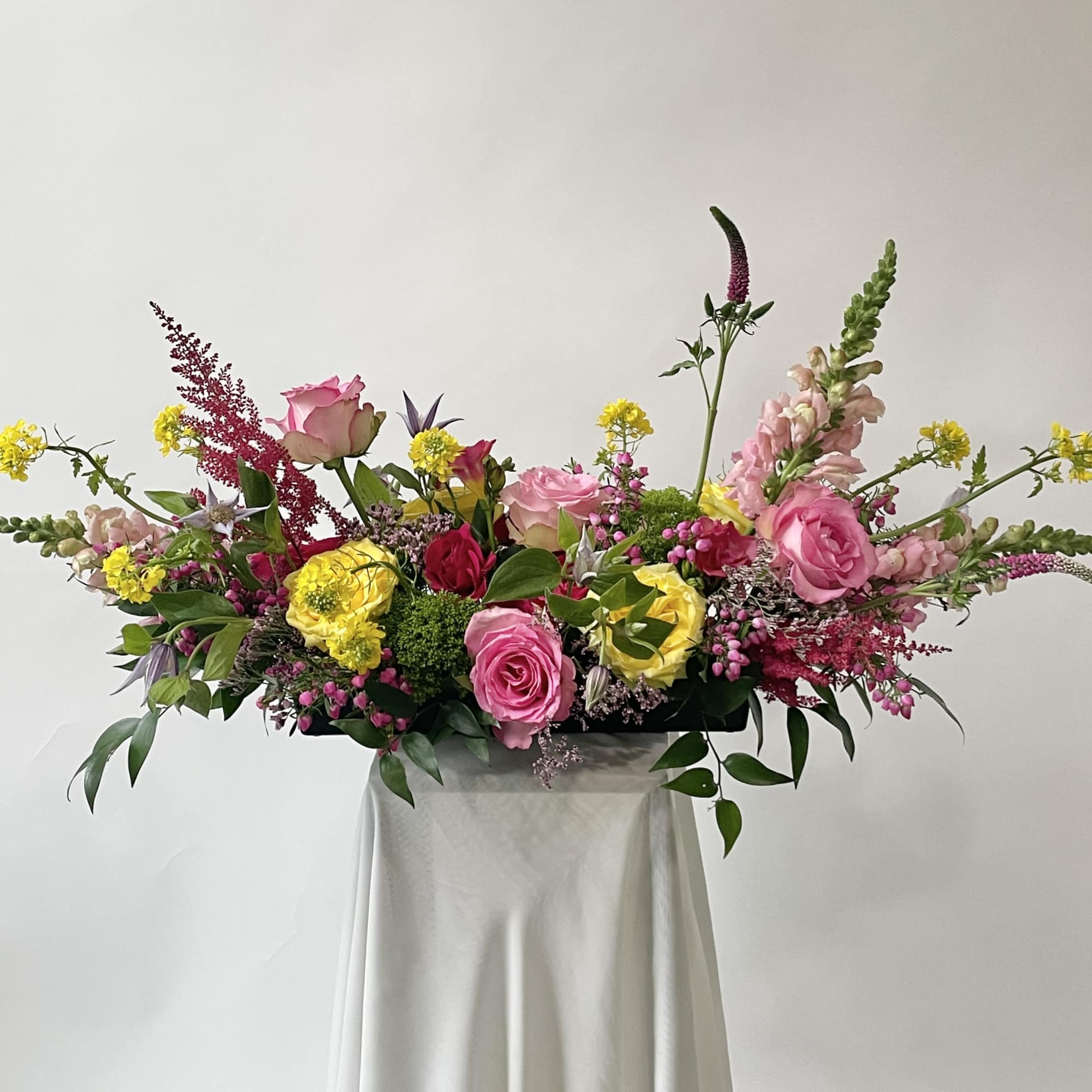 Large mixed bouquet with pink and yellow roses and tall accent flowers