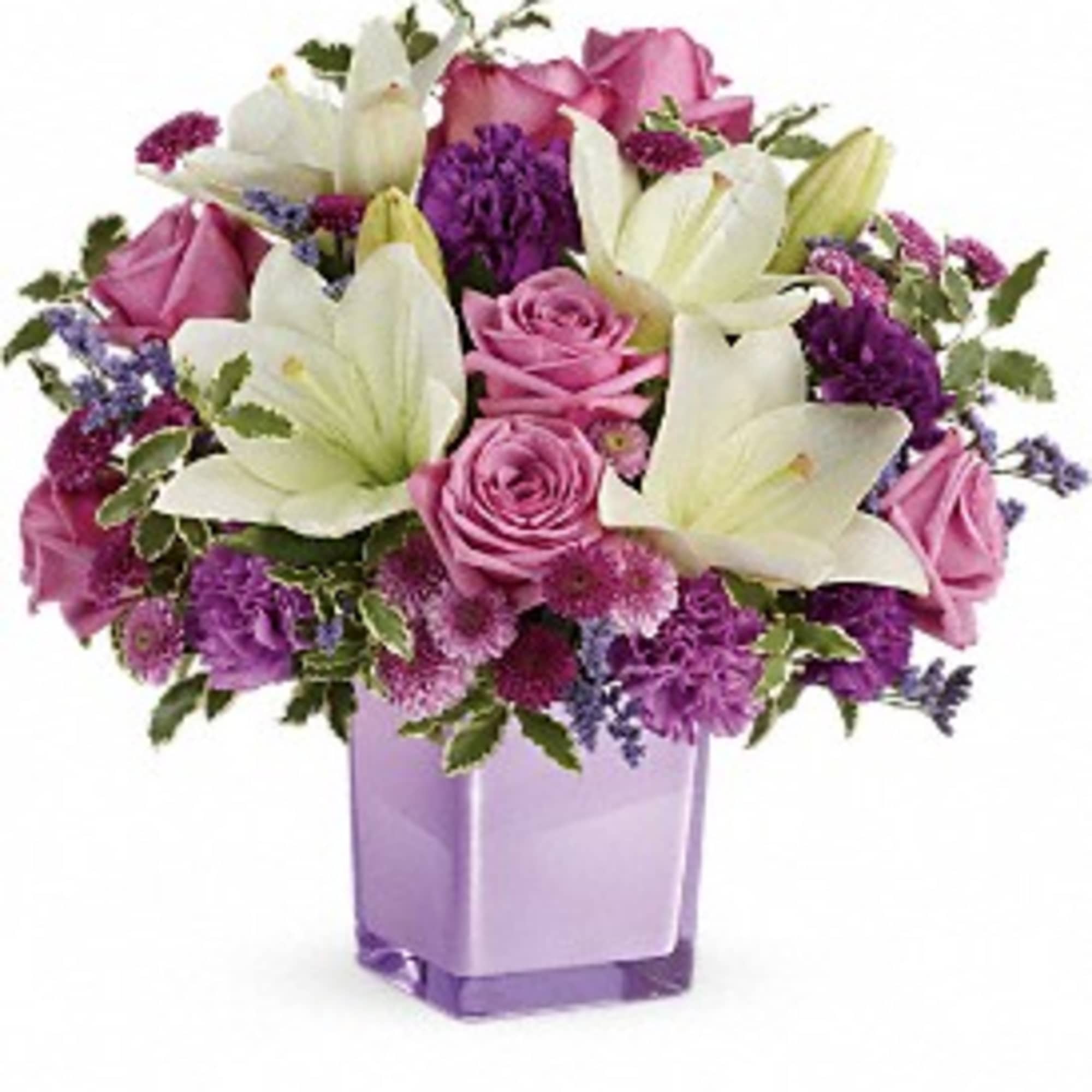 Pink roses and white lilies in a purple glass vase