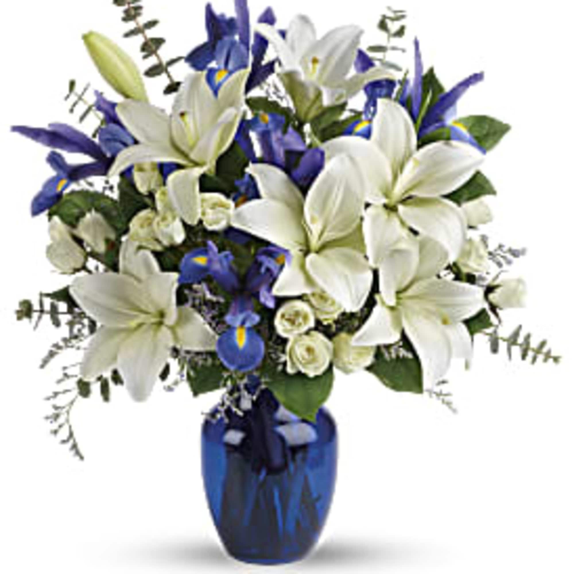 White lilies and blue iris in a cobalt vase
