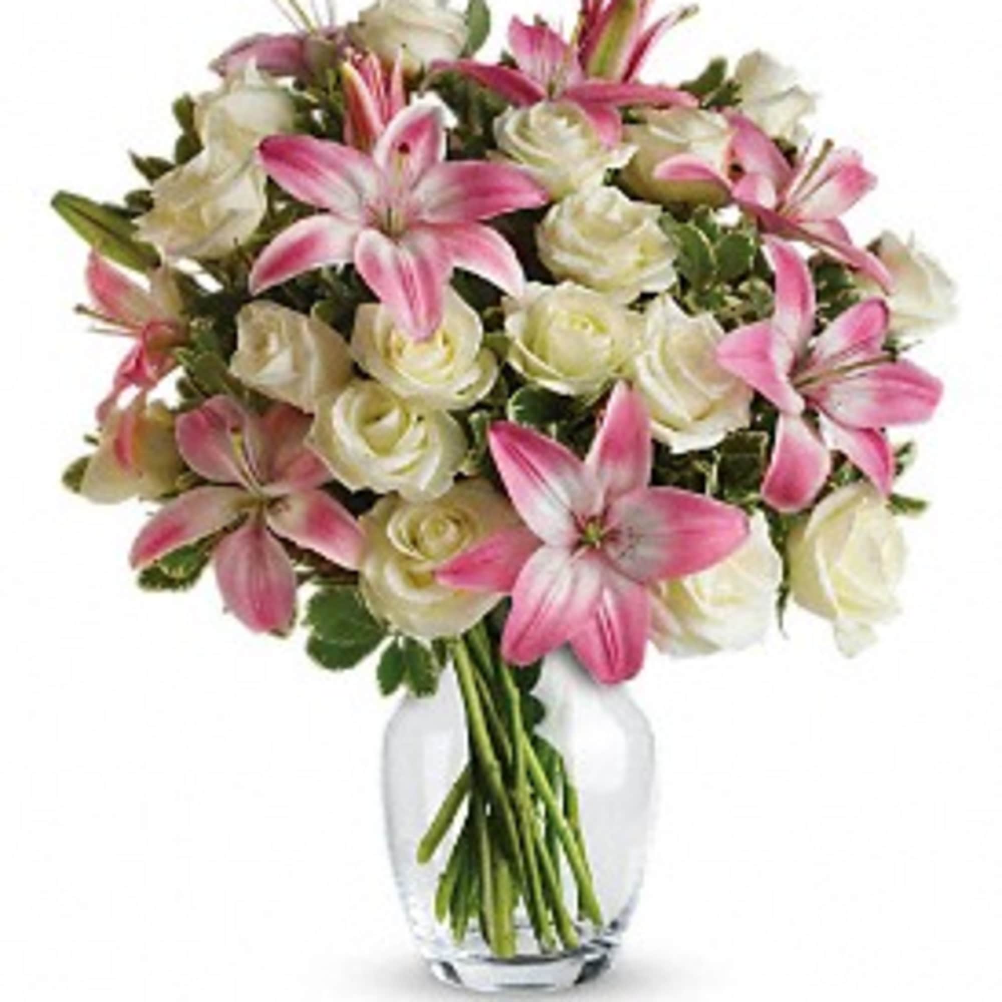 Pink lilies and white roses in a clear glass vase