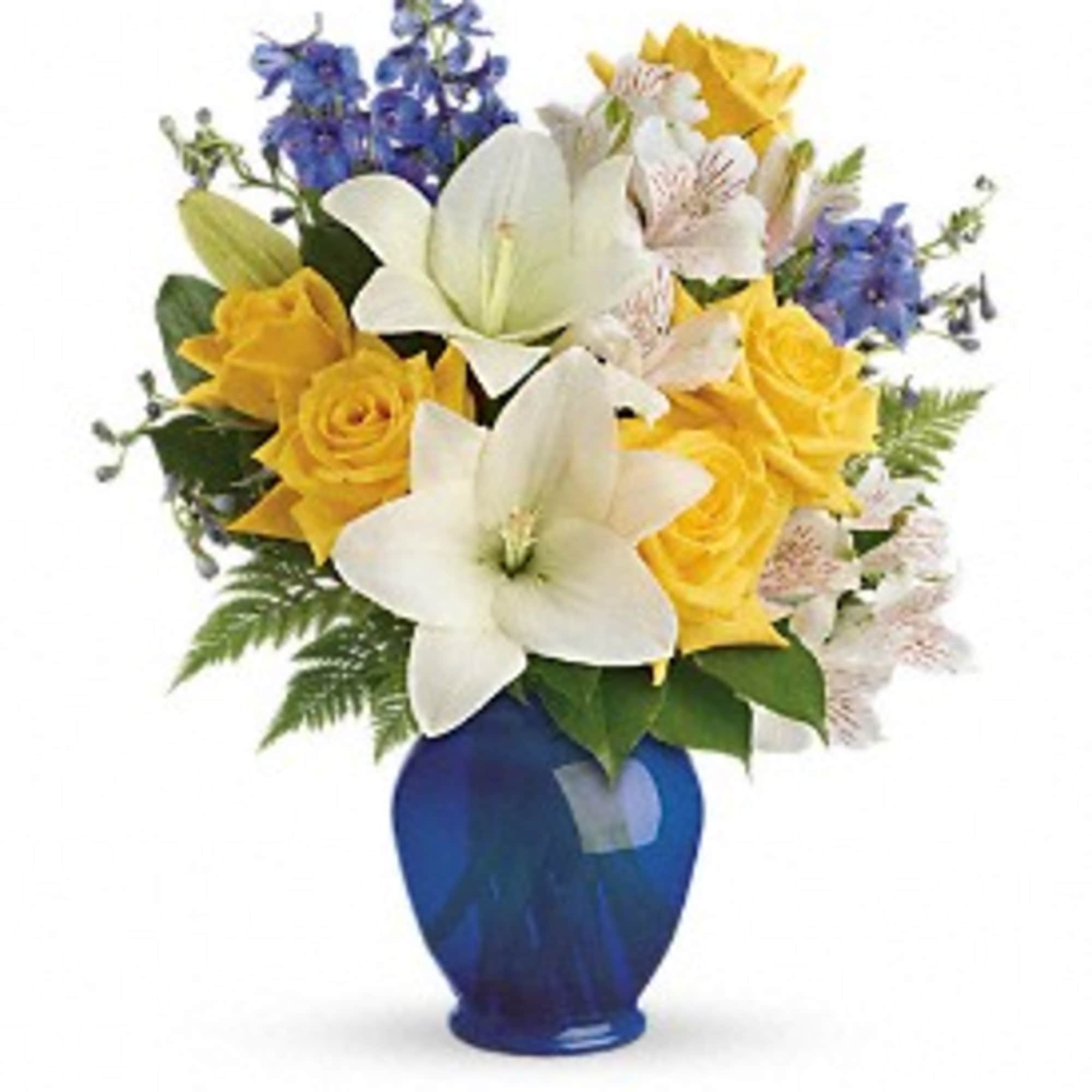Bouquet of yellow roses, white lilies, and blue flowers in a blue vase