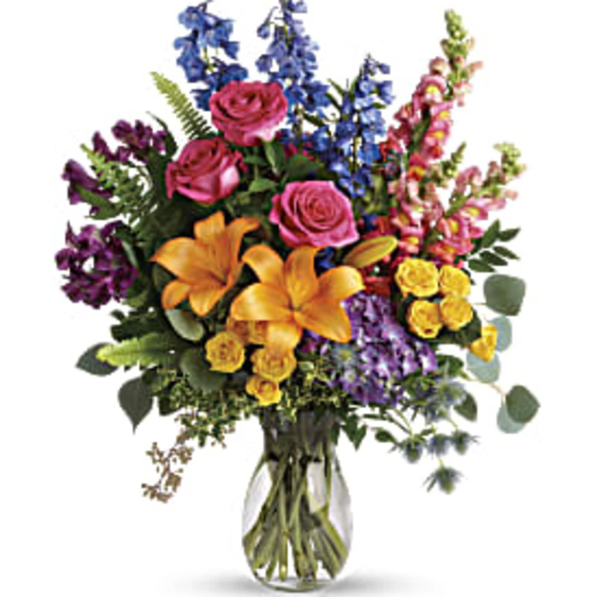 Mixed bouquet of roses, lilies, and snapdragons in a glass vase