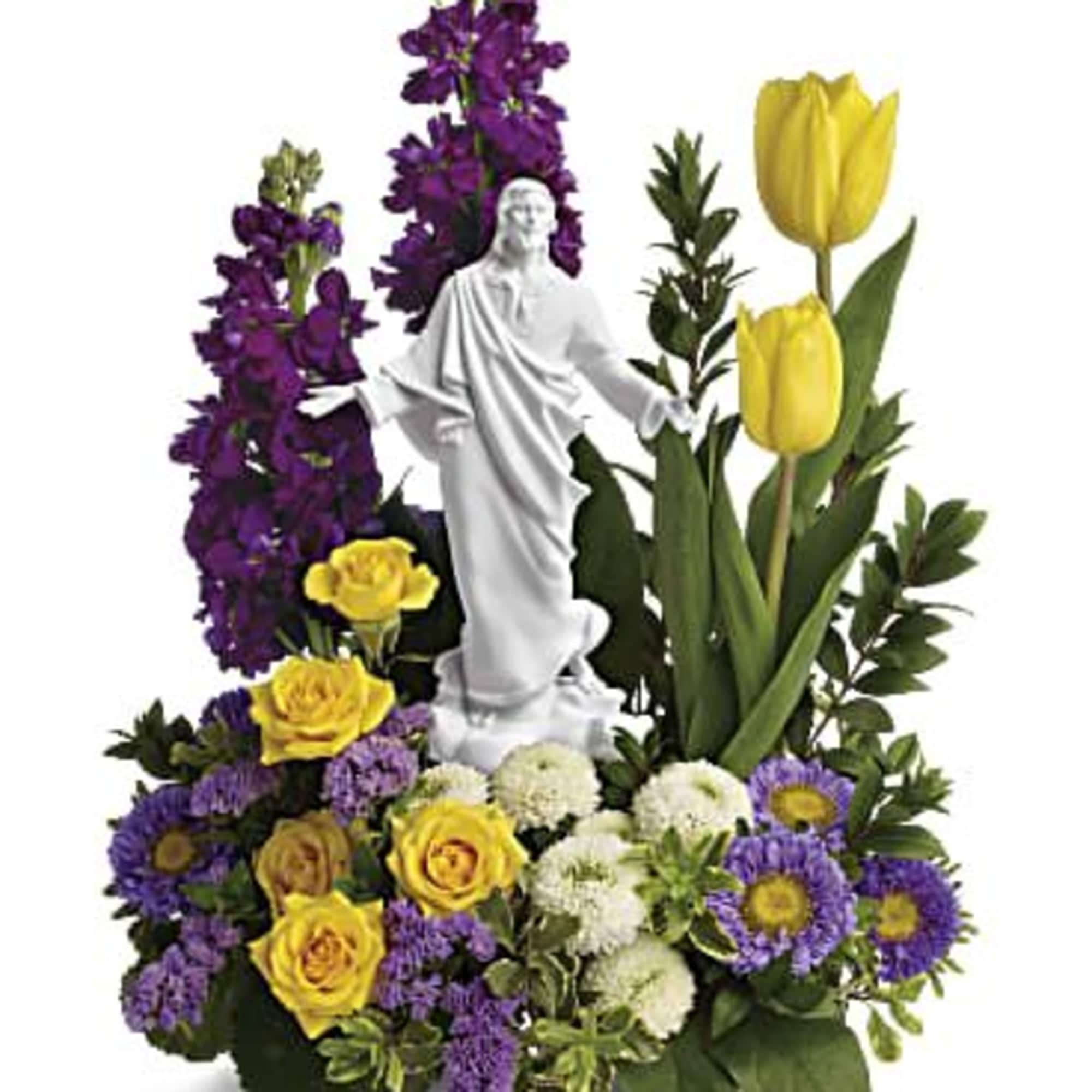 Floral arrangement with a white statue centerpiece, yellow tulips, and purple flowers