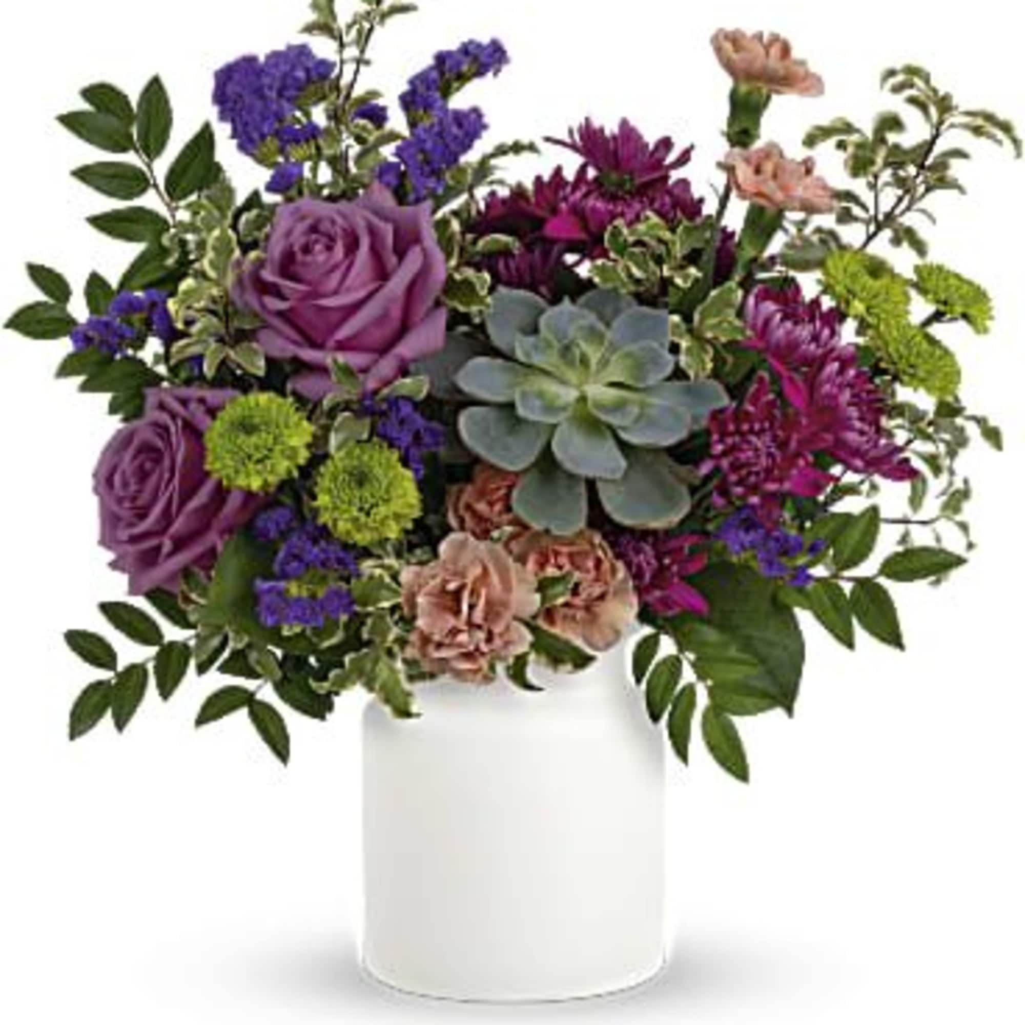 Purple and pink floral arrangement in a white vase