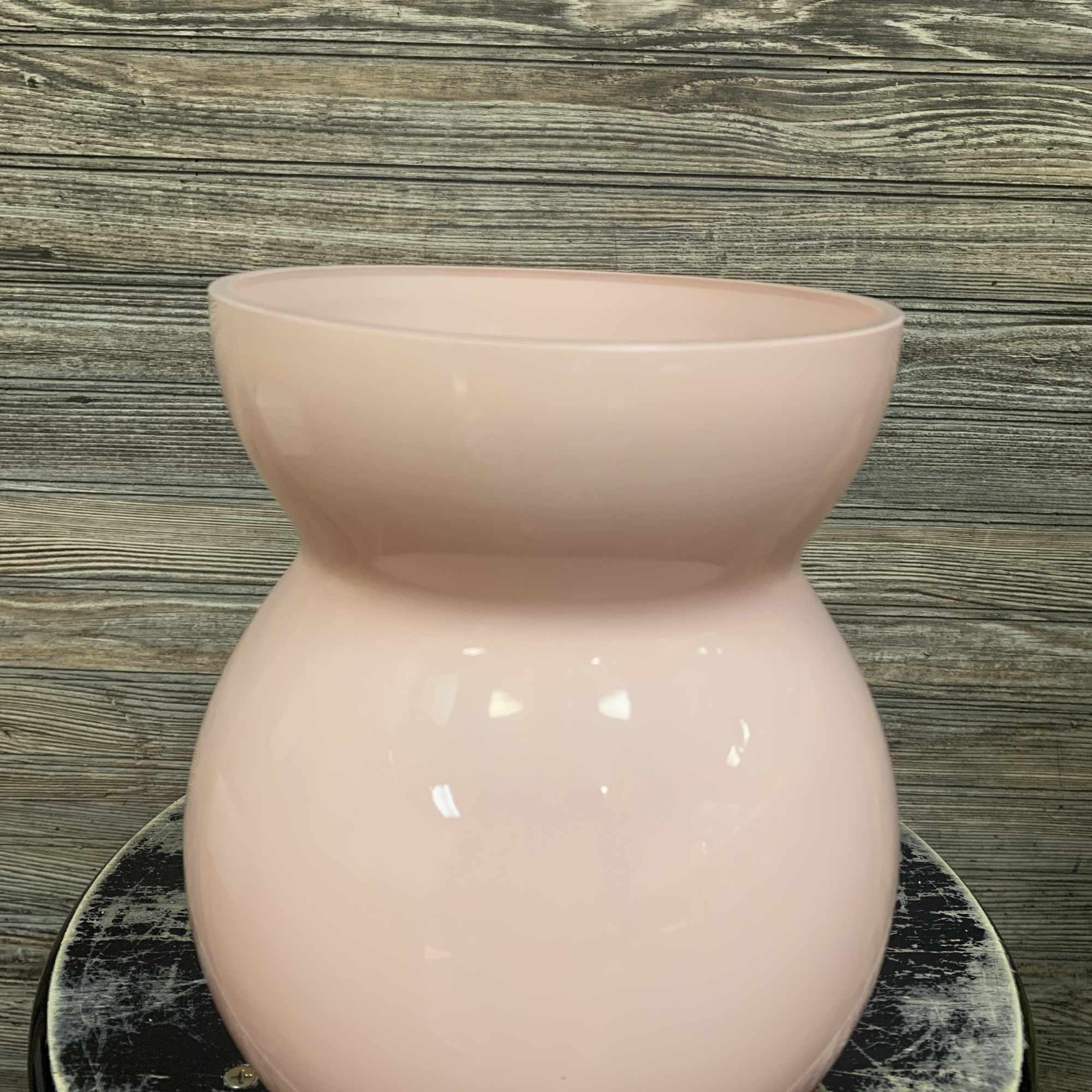Pink ceramic vase on a round base