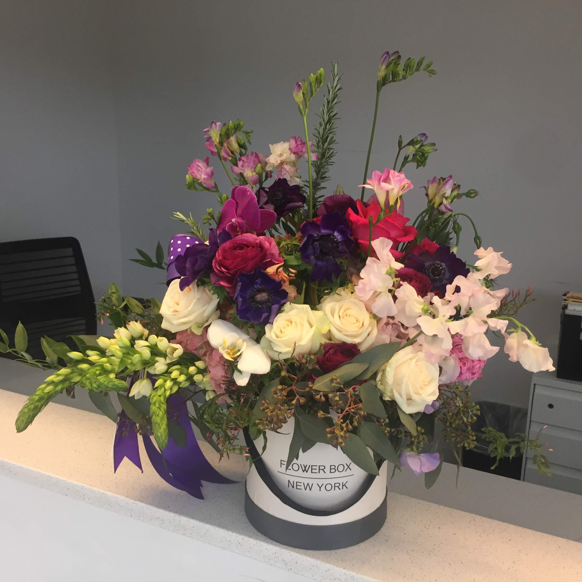 Mixed bouquet in a round Flower Box New York container