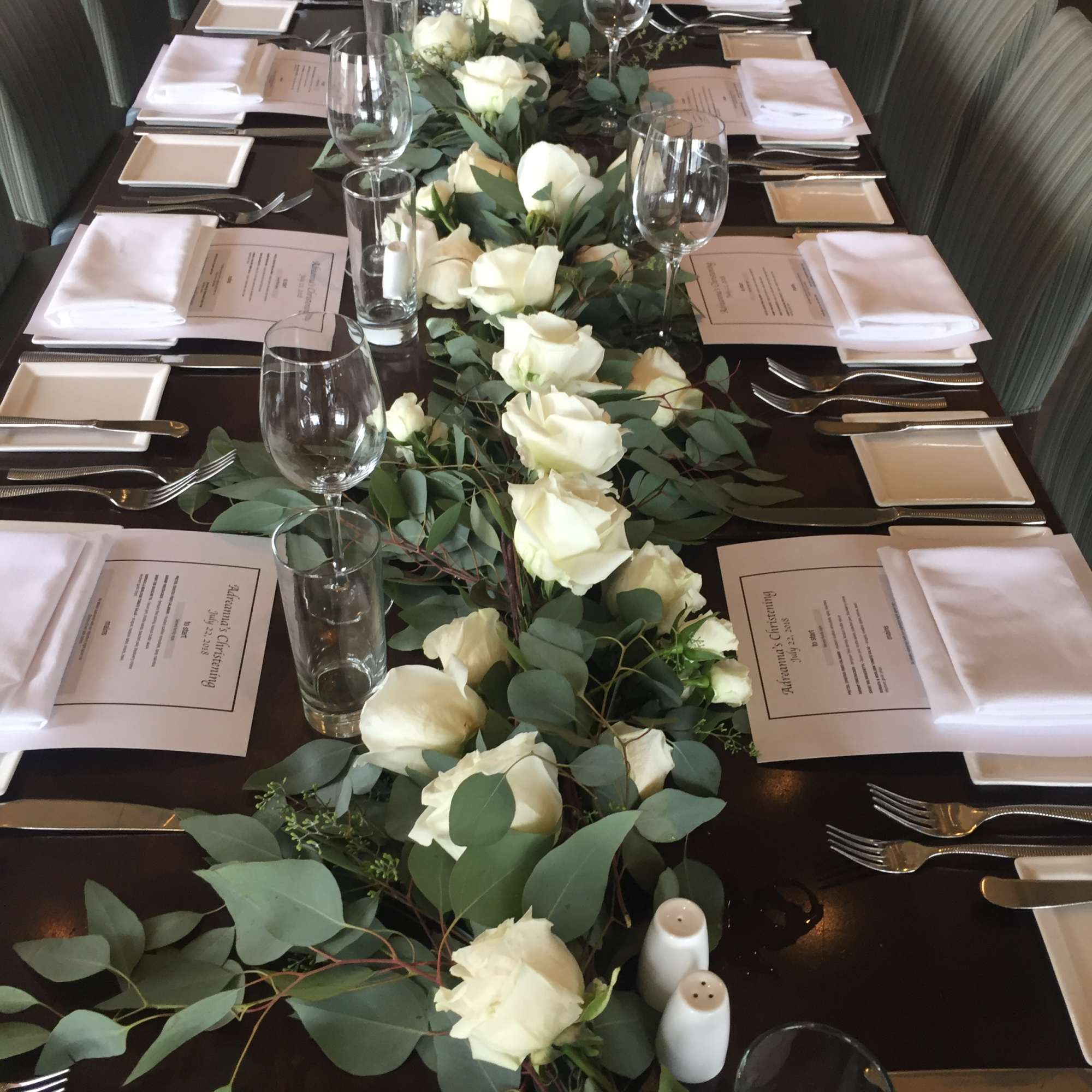 Long table centerpiece with white roses and eucalyptus