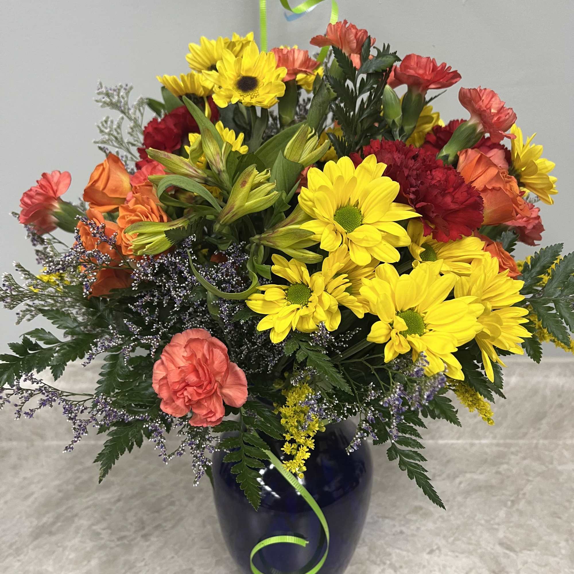 Blue vase with rainbow of colors of fresh flowers and a mylar, photo 2 of 2