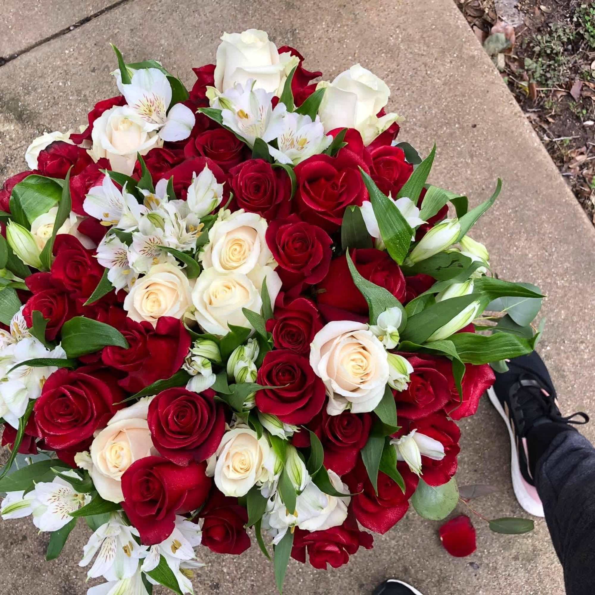 Large bouquet of red and white roses with white alstroemeria