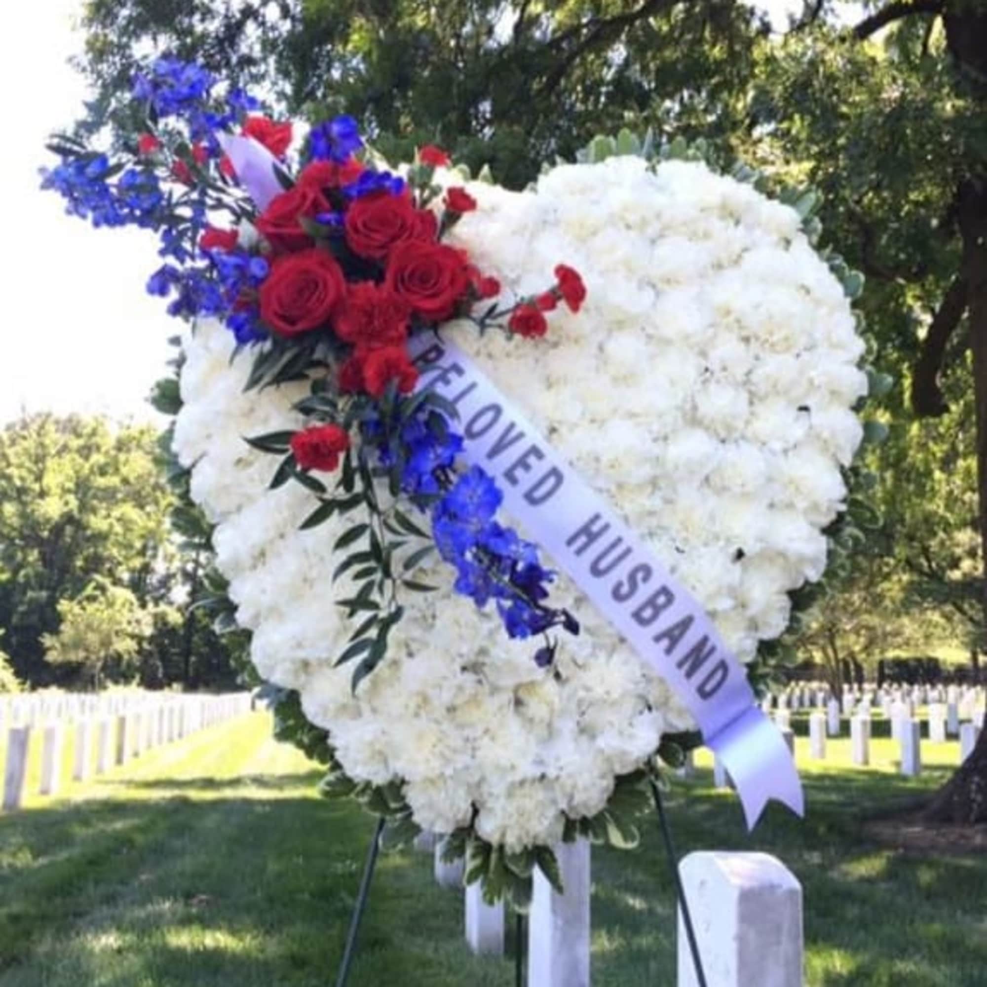 PATRIOTS HEART ON EASEL WITH PRINTED SASH  BY TWIN TOWERS FLORIST.