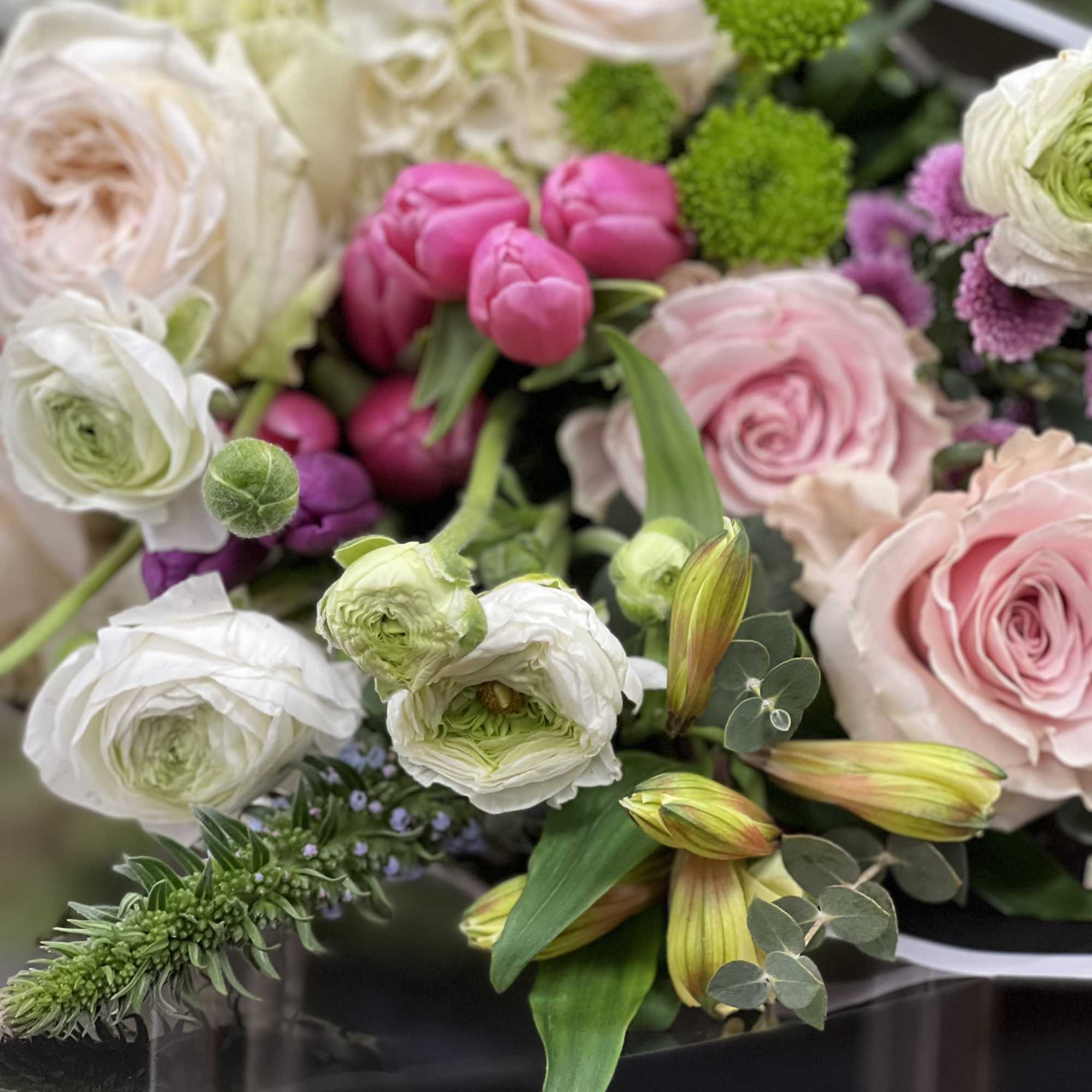 Bouquet of pink and white flowers with green accents