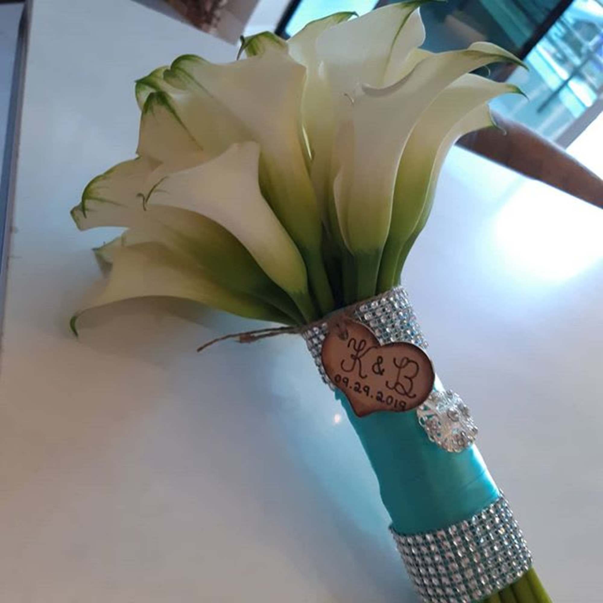 White calla lily bouquet with a turquoise handle and rhinestone accents